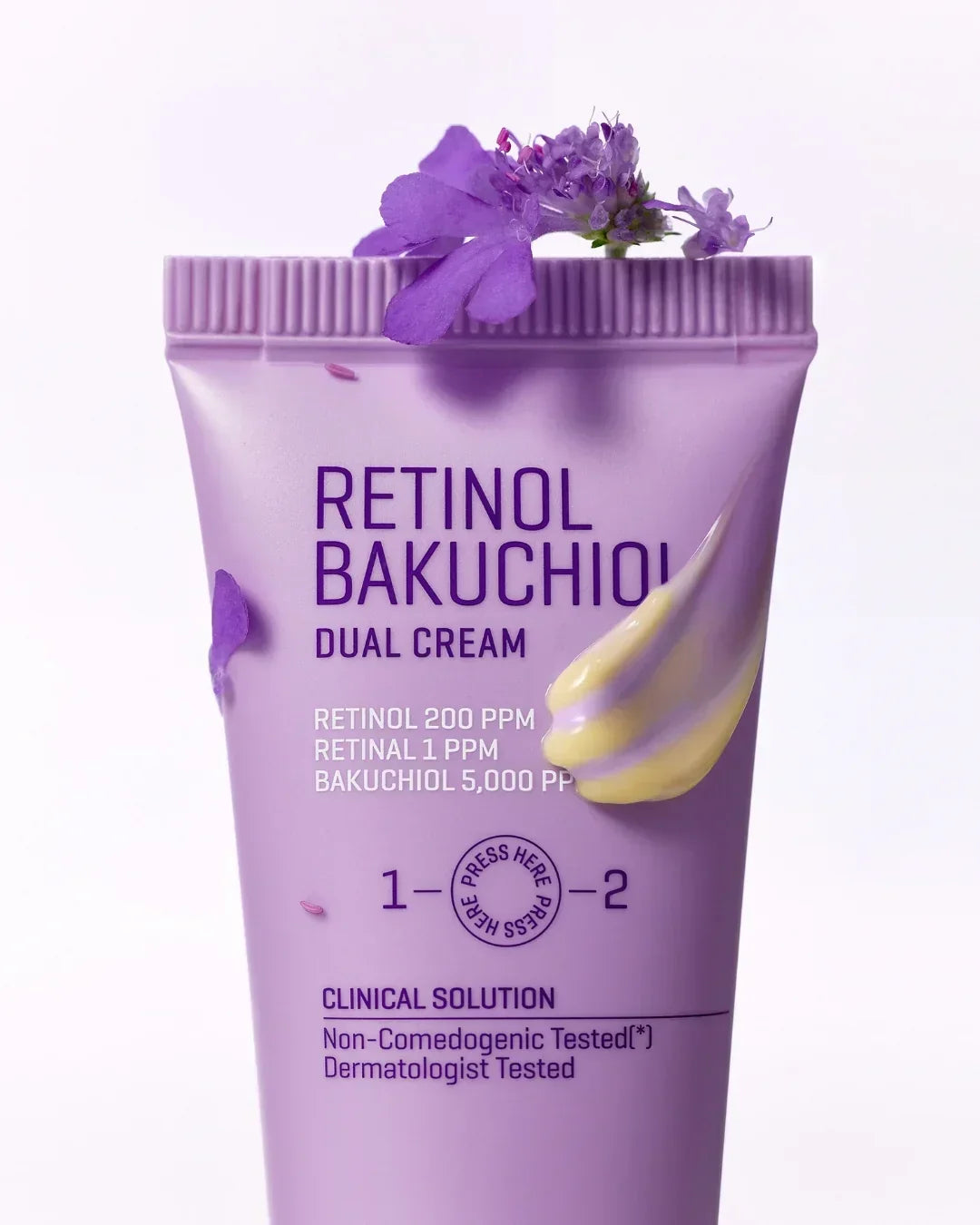 Purple tube of Retinol Bakuchiol Dual Cream with floral decoration and skincare cream swatch