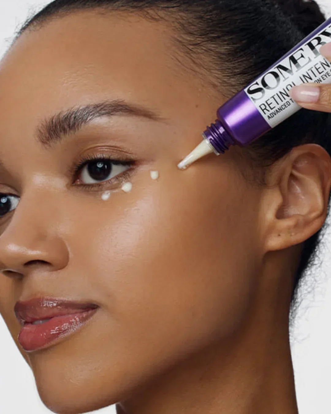 Woman applying Somerville retinol intense advanced triple action eye cream to under eye