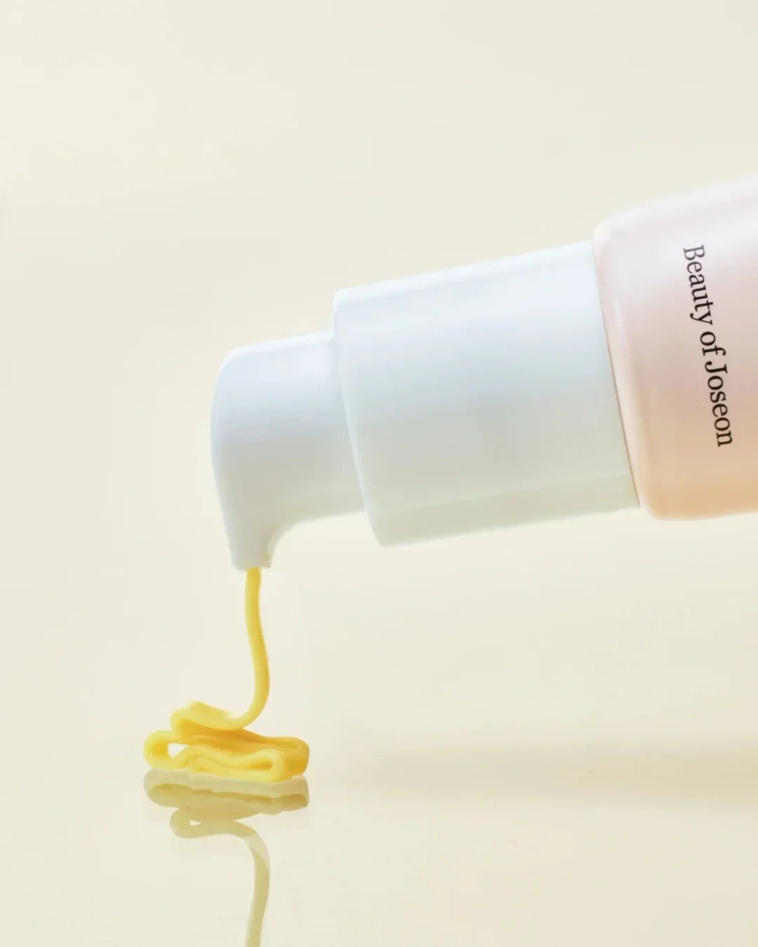 Beauty of Joseon skincare serum with yellow cream texture dispensing from white pump bottle