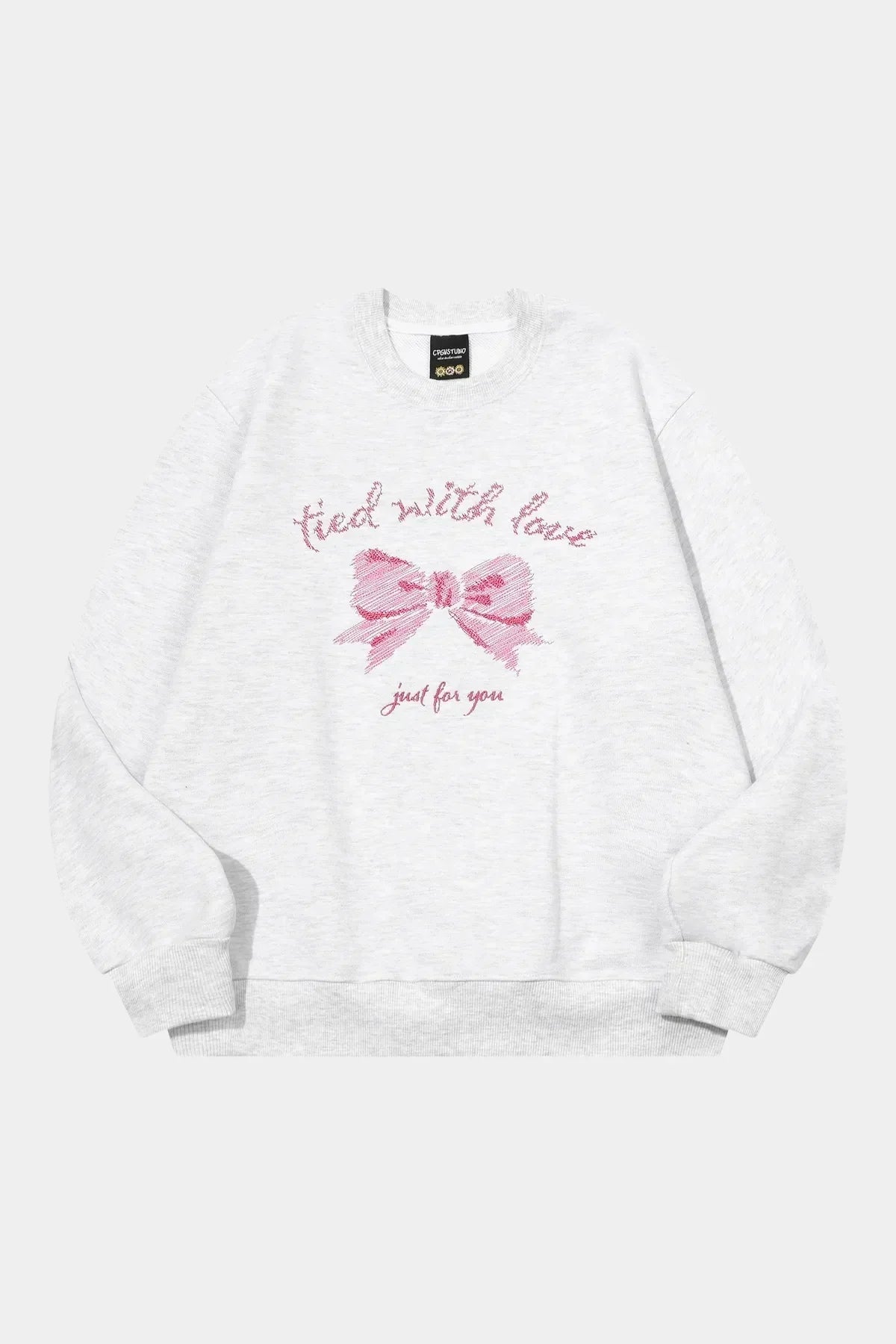 Light gray sweatshirt with pink embroidered bow and text tied with love just for you