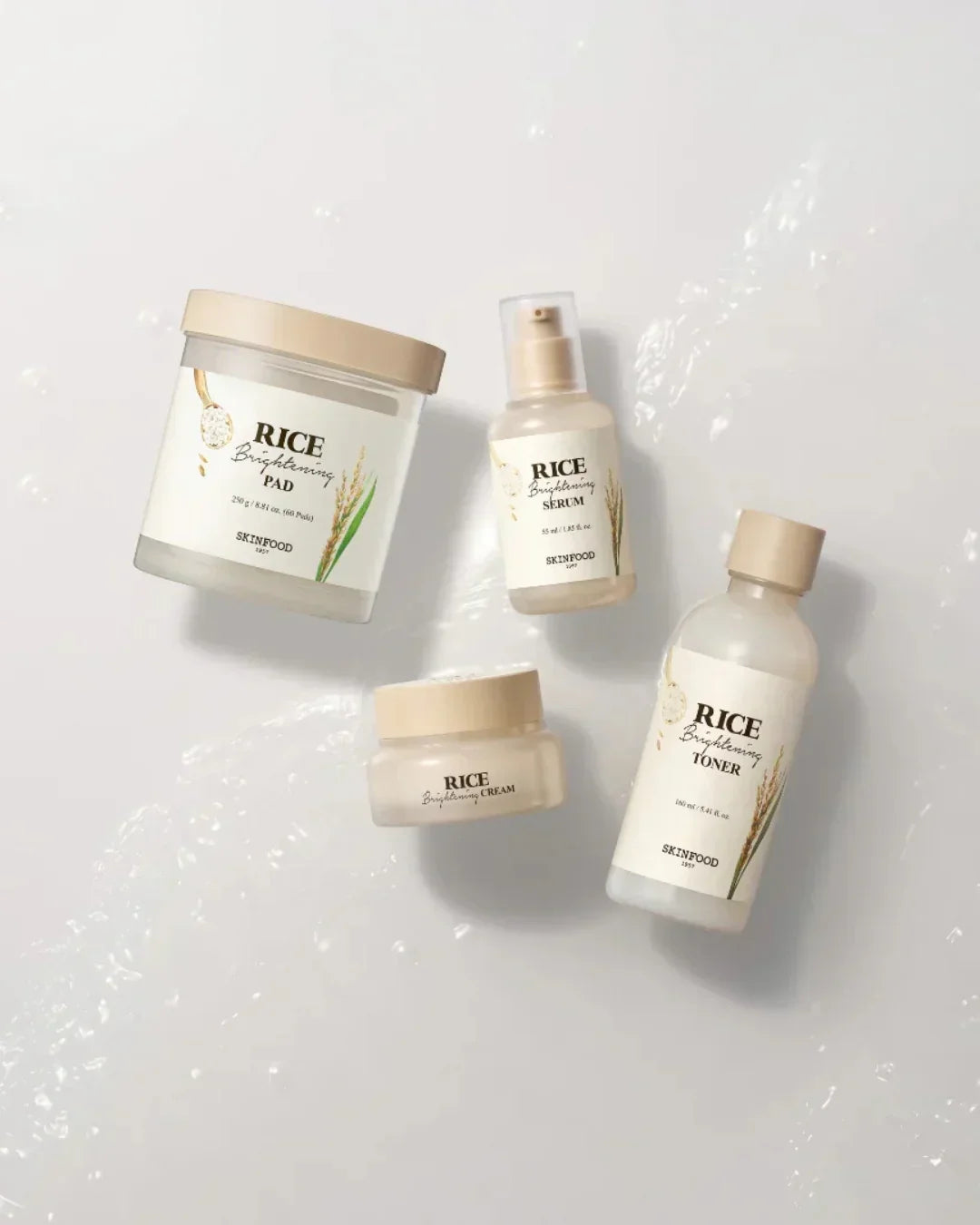 Skinfood Rice Brightening skincare set with cream, toner, serum, and pads on white surface
