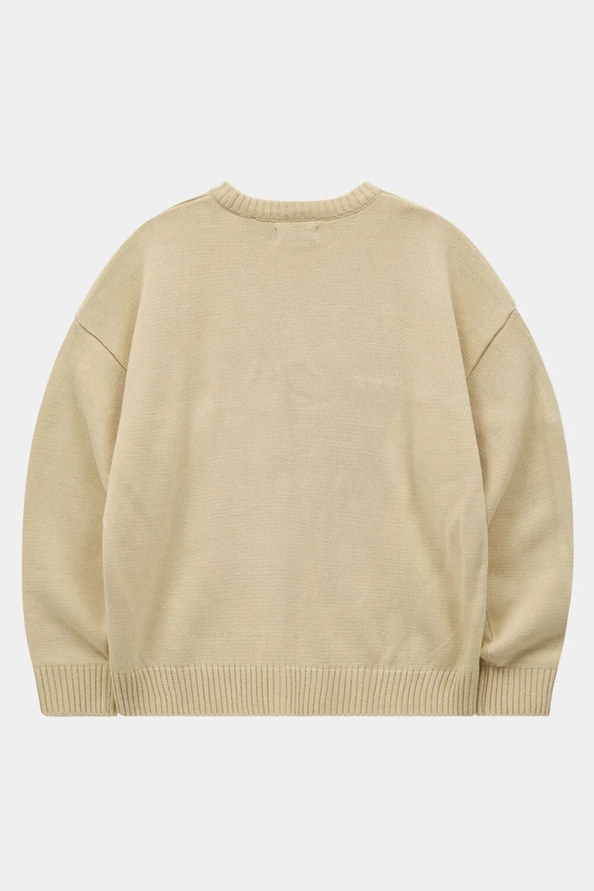 Back view of an ivory oversized knit sweater with ribbed cuffs and hem on a white background