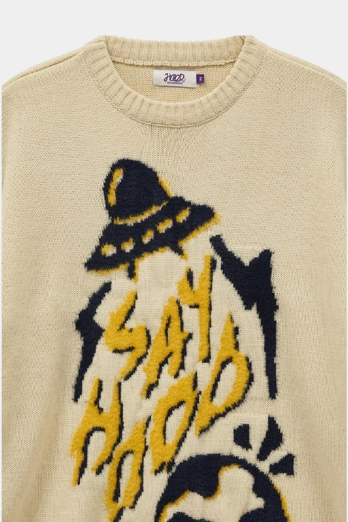Ivory knit sweater with yellow and black UFO and Say Hood text graphic detail