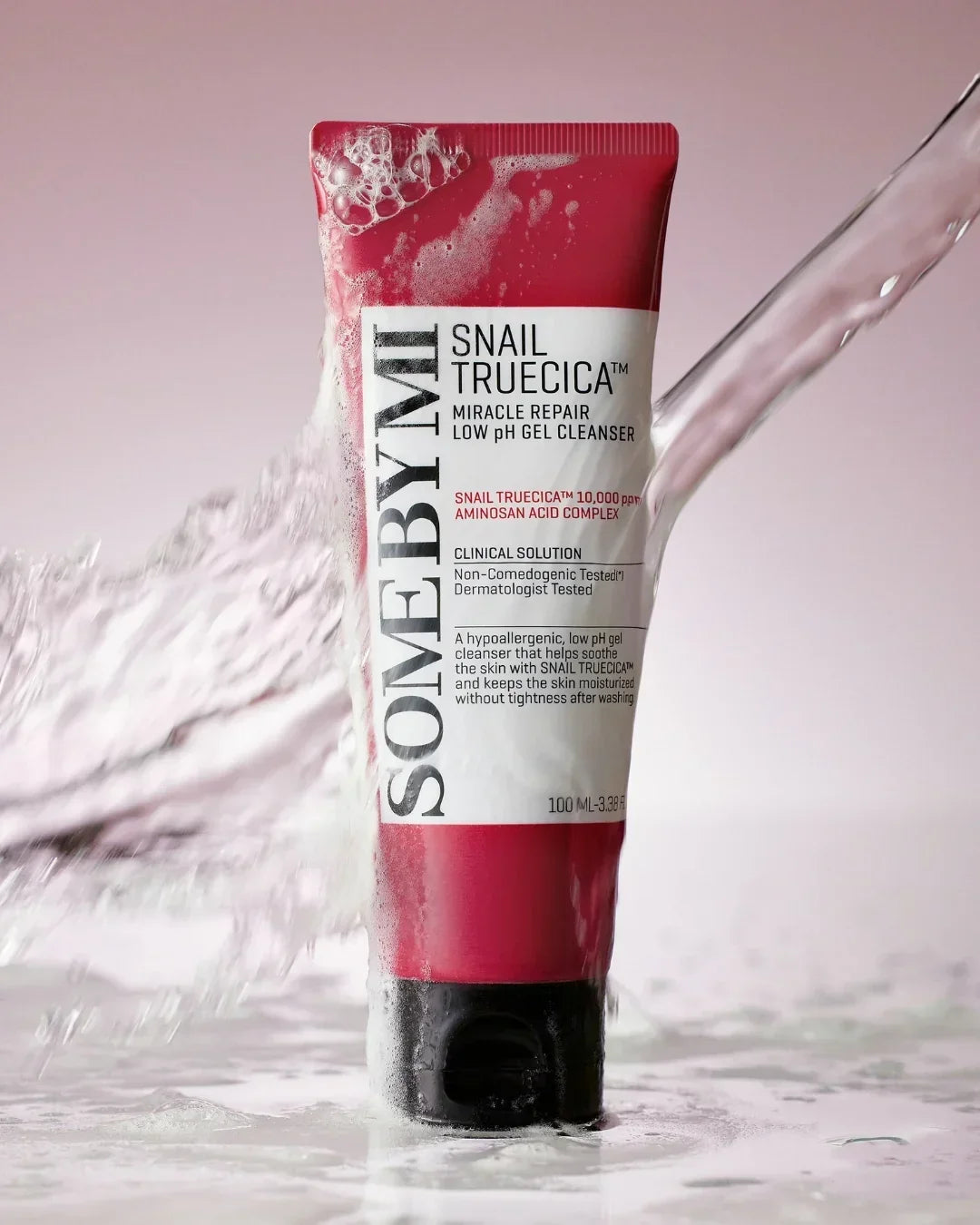 Some By Mi Snail Truecica Miracle Repair low pH gel cleanser tube with splashing water on pink background