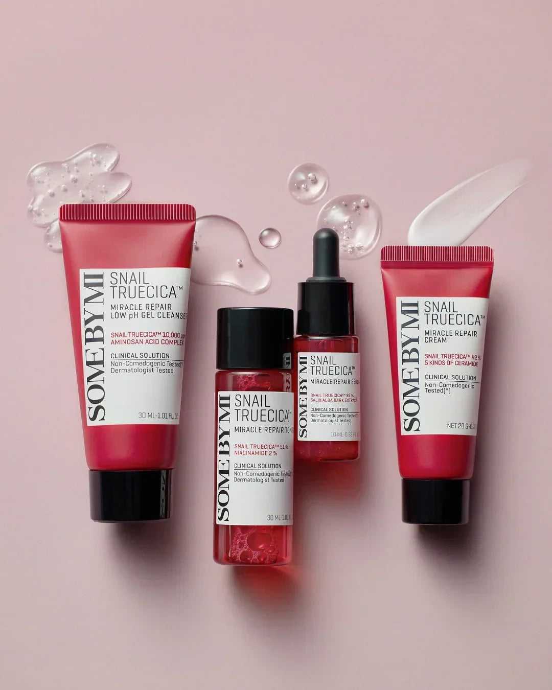 Some By Mi Snail Truecica Miracle Repair skincare set with cleanser, toner, serum, and cream on pink background
