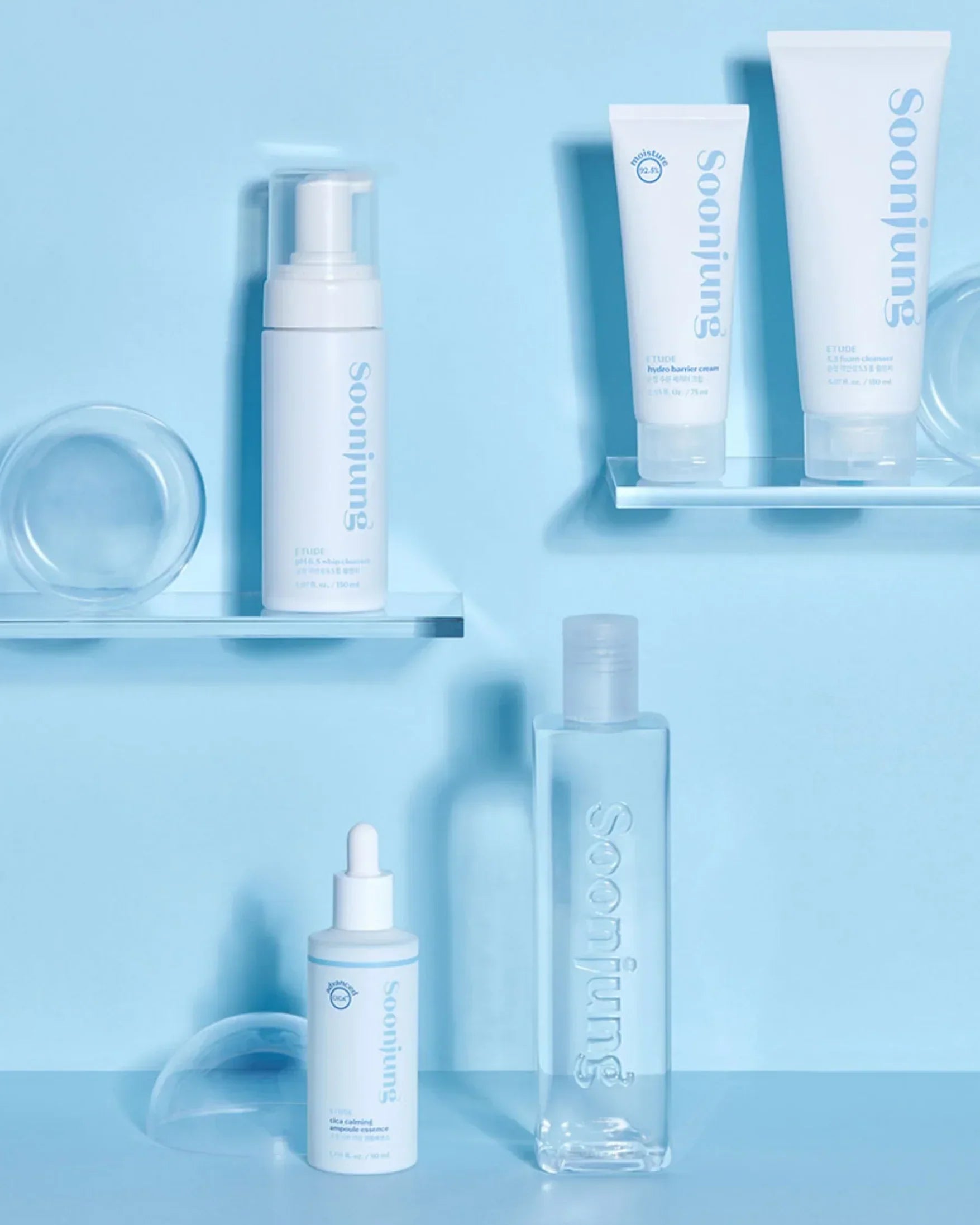 Soojung skincare set with cleanser, cream, essence, and toner on blue background
