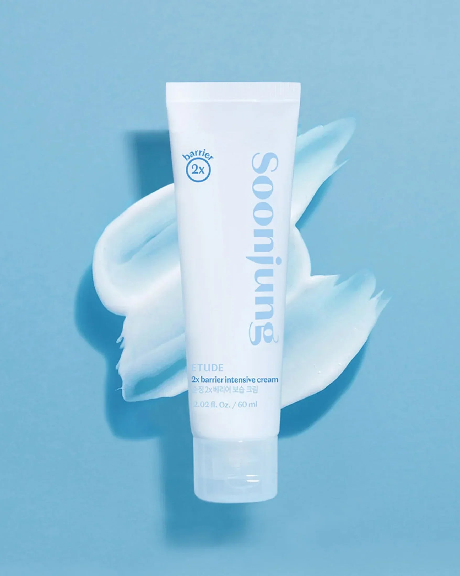 Soonjung 2x barrier intensive cream tube on blue background with cream texture smear