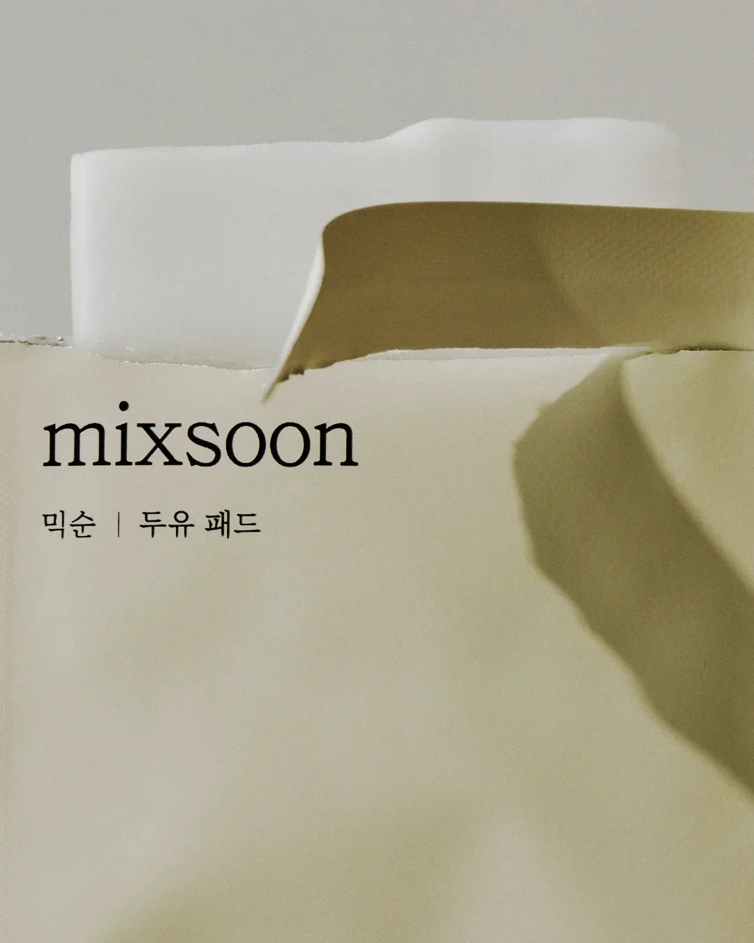 Mixsoon soybean milk pad package with torn beige and white paper background