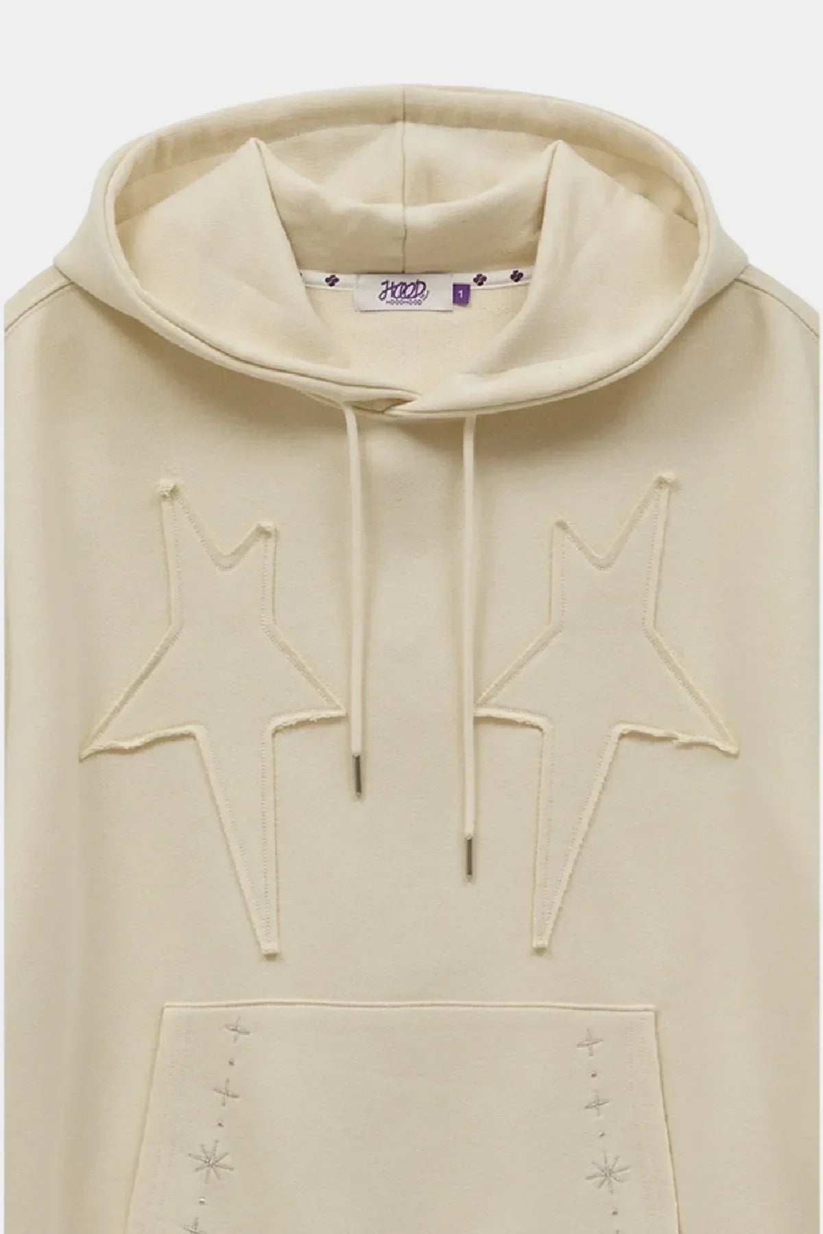 Ivory hoodie with star-shaped appliqué embroidery and front pocket with subtle star details
