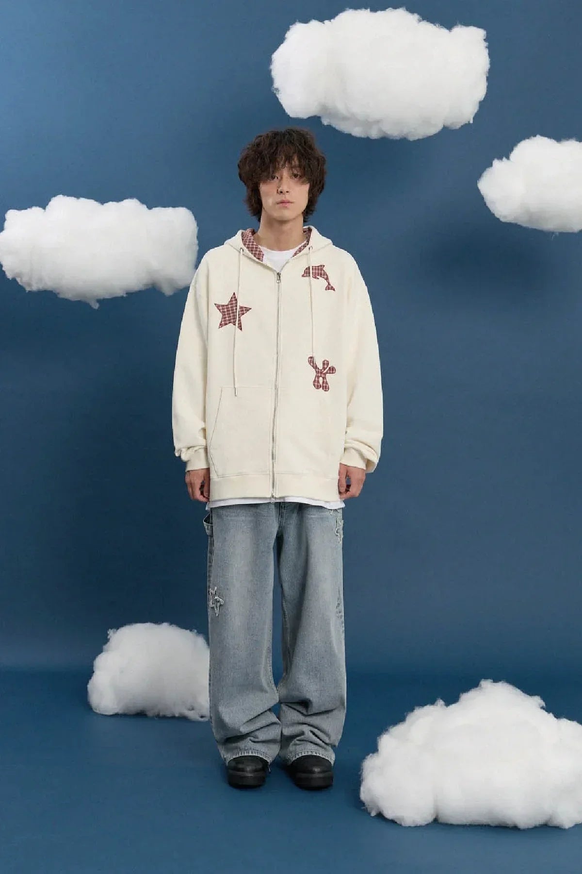 Model wearing ivory hooded zip-up with check applique stars and dolphins, wide denim jeans; Korean fashion style, Malkn.