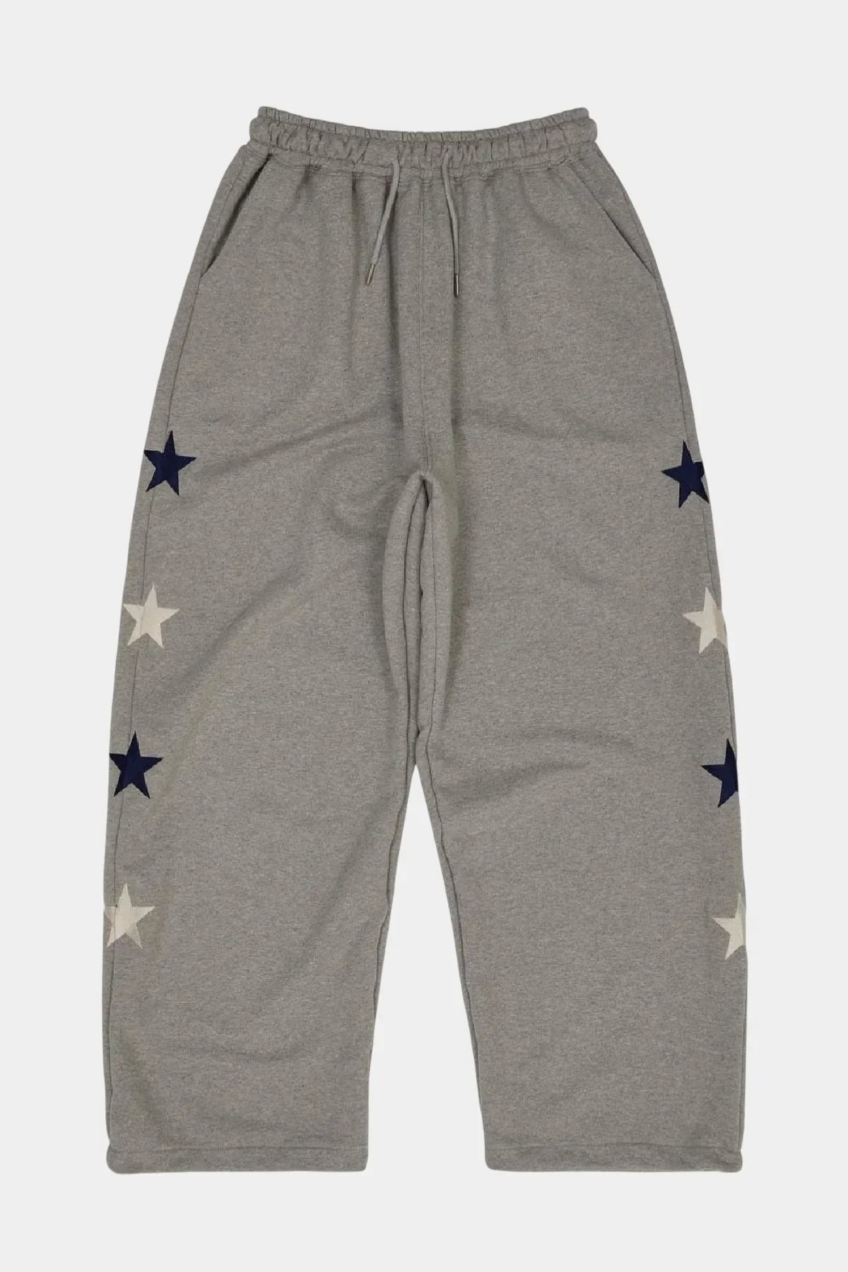 Grey sweatpants with elastic waistband and navy blue and white star patterns on sides