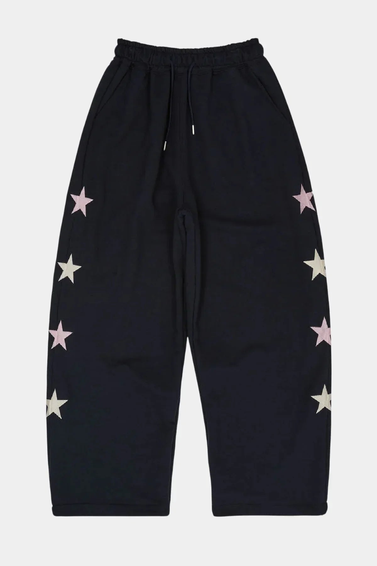 Navy sweatpants with pink and white star designs along the sides and elastic waistband