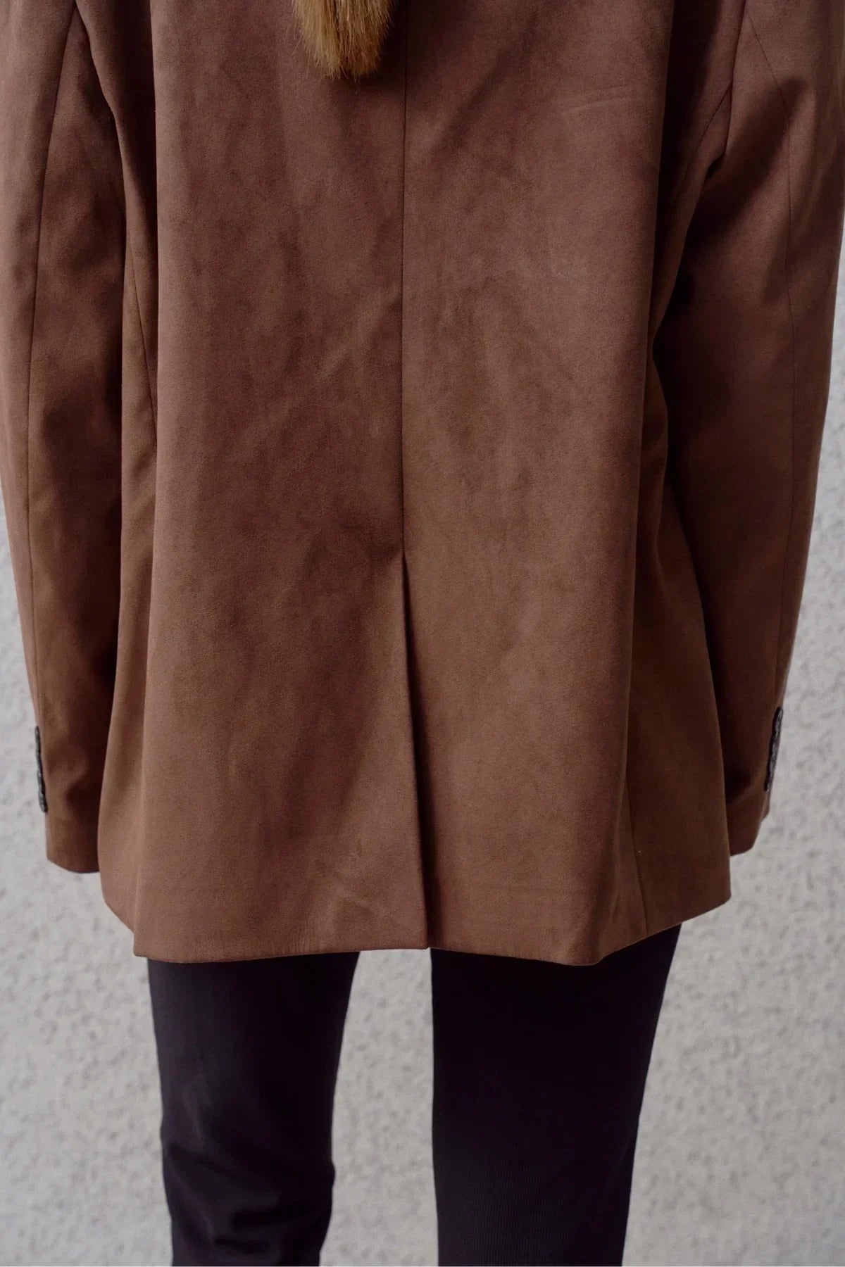 Back view of brown suede blazer with center vent and black pants