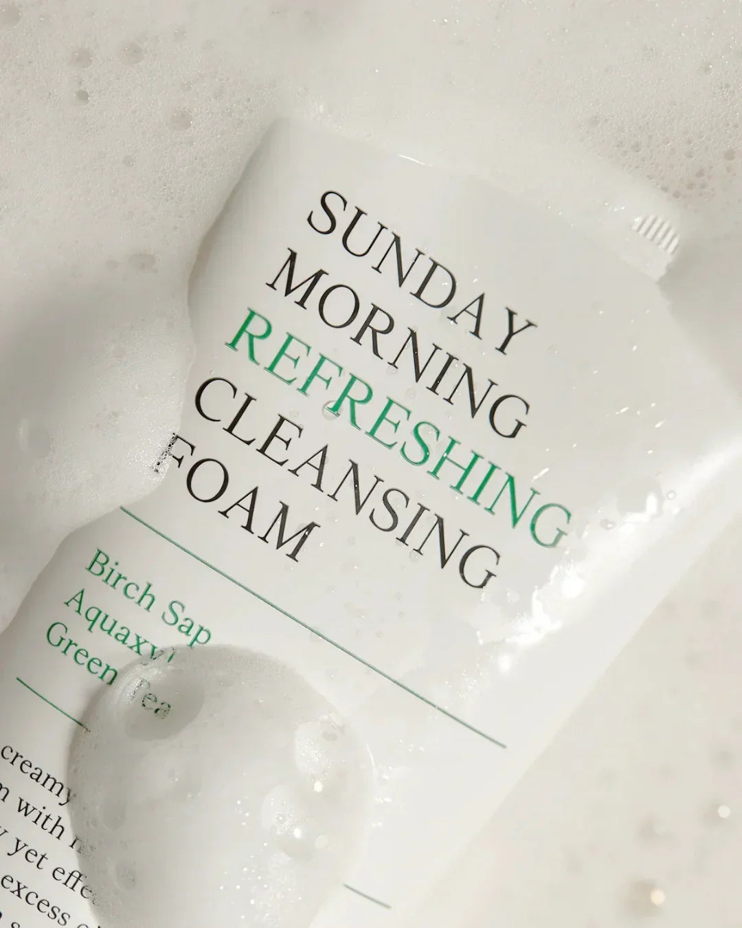 Sunday Morning Refreshing Cleansing Foam tube with foam bubbles, featuring birch sap and green tea ingredients