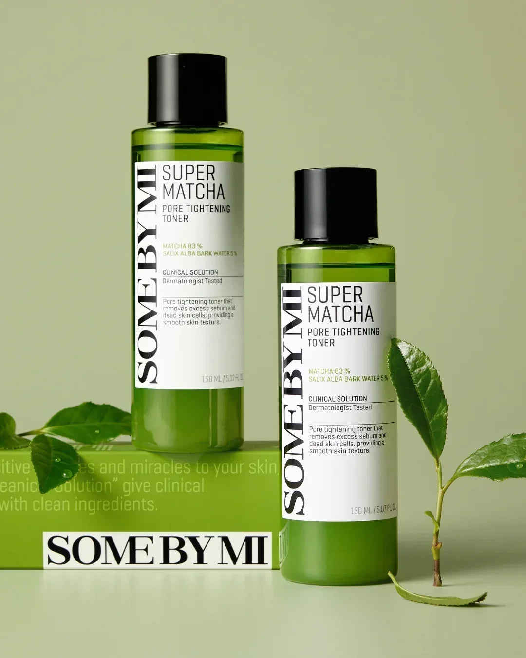 Two green bottles of Some By Mi Super Matcha Pore Tightening Toner with black caps on a green background with leaves