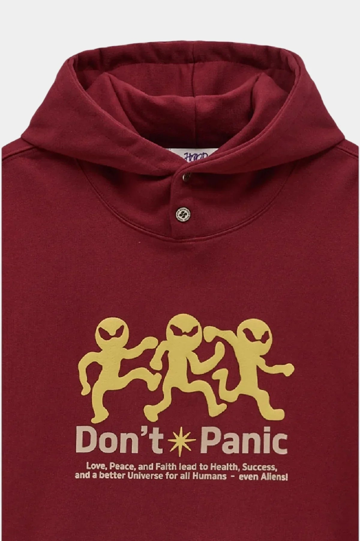 Burgundy hoodie with three yellow dancing alien figures and text 'Don't Panic' and a positive message