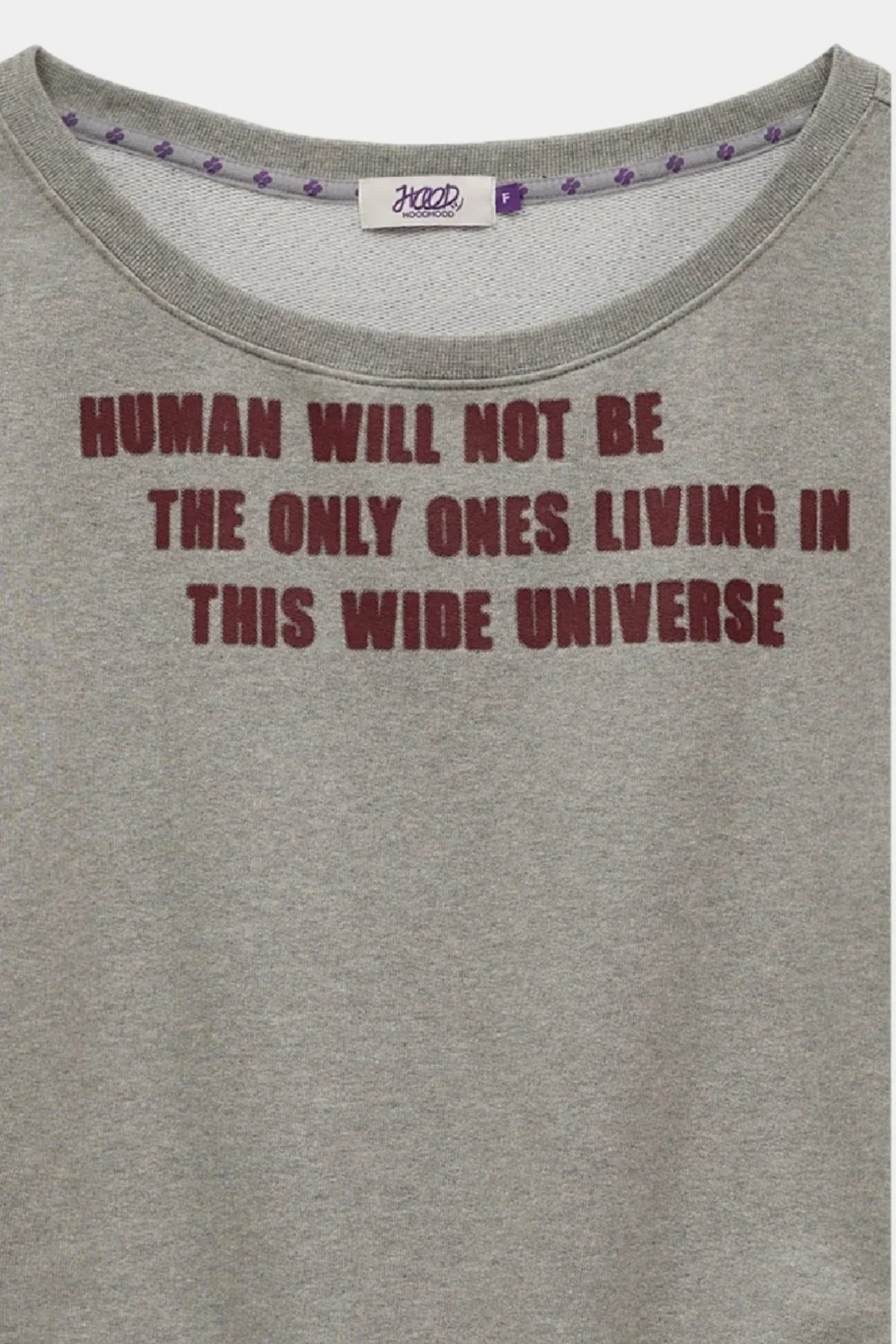 Gray sweatshirt with maroon text reading 'HUMAN WILL NOT BE THE ONLY ONES LIVING IN THIS WIDE UNIVERSE' and small purple printed trim inside collar