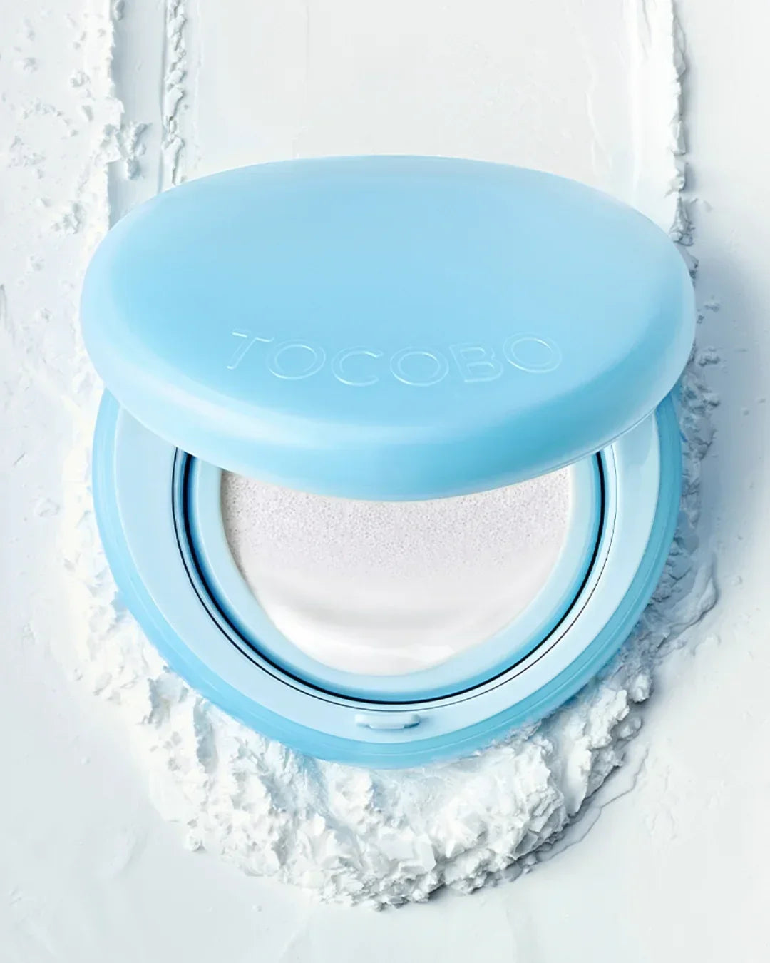 Open Tocobo Blur Finish Sun Cushion with light blue case on white textured surface