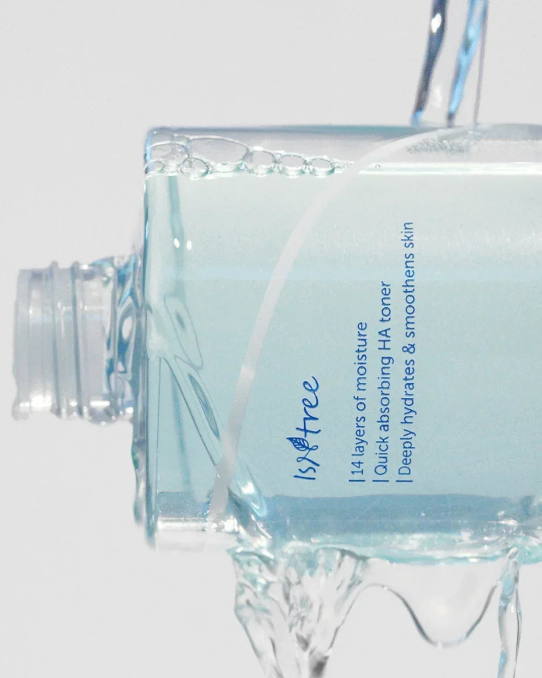 Isntree 114 layers of moisture quick absorbing HA toner bottle with water pouring over