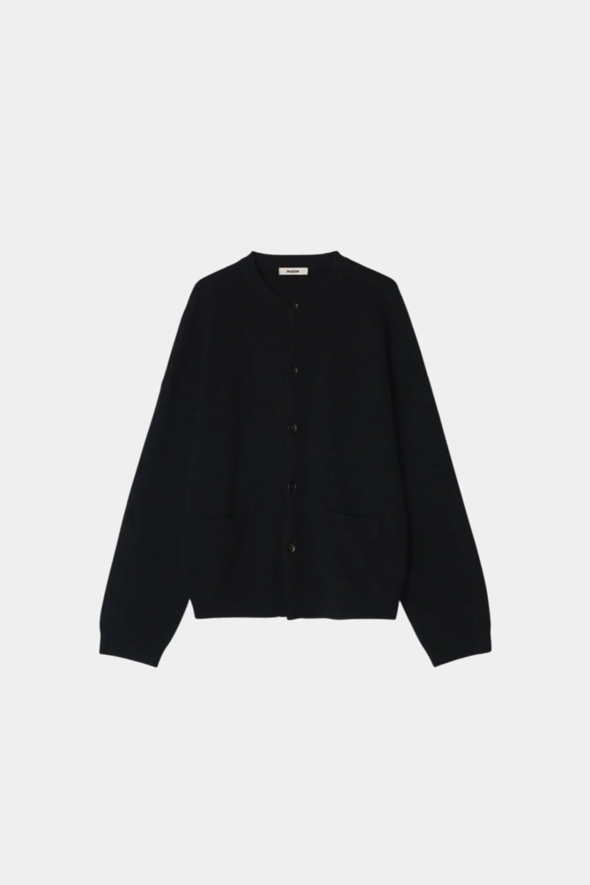 Black unisex cashmere cardigan with buttons and front pockets on white background