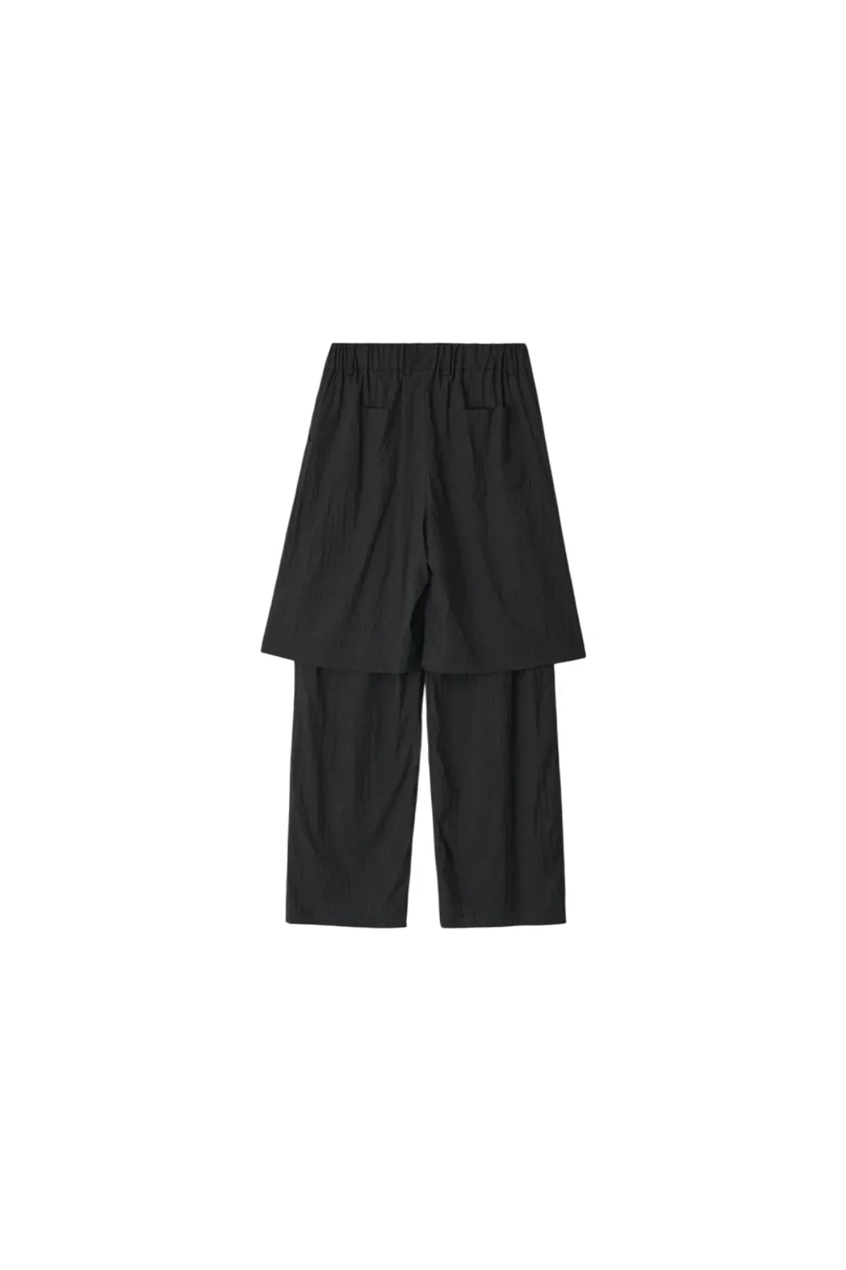 Back view of unisex black layered pants with elastic waist and straight legs on white background