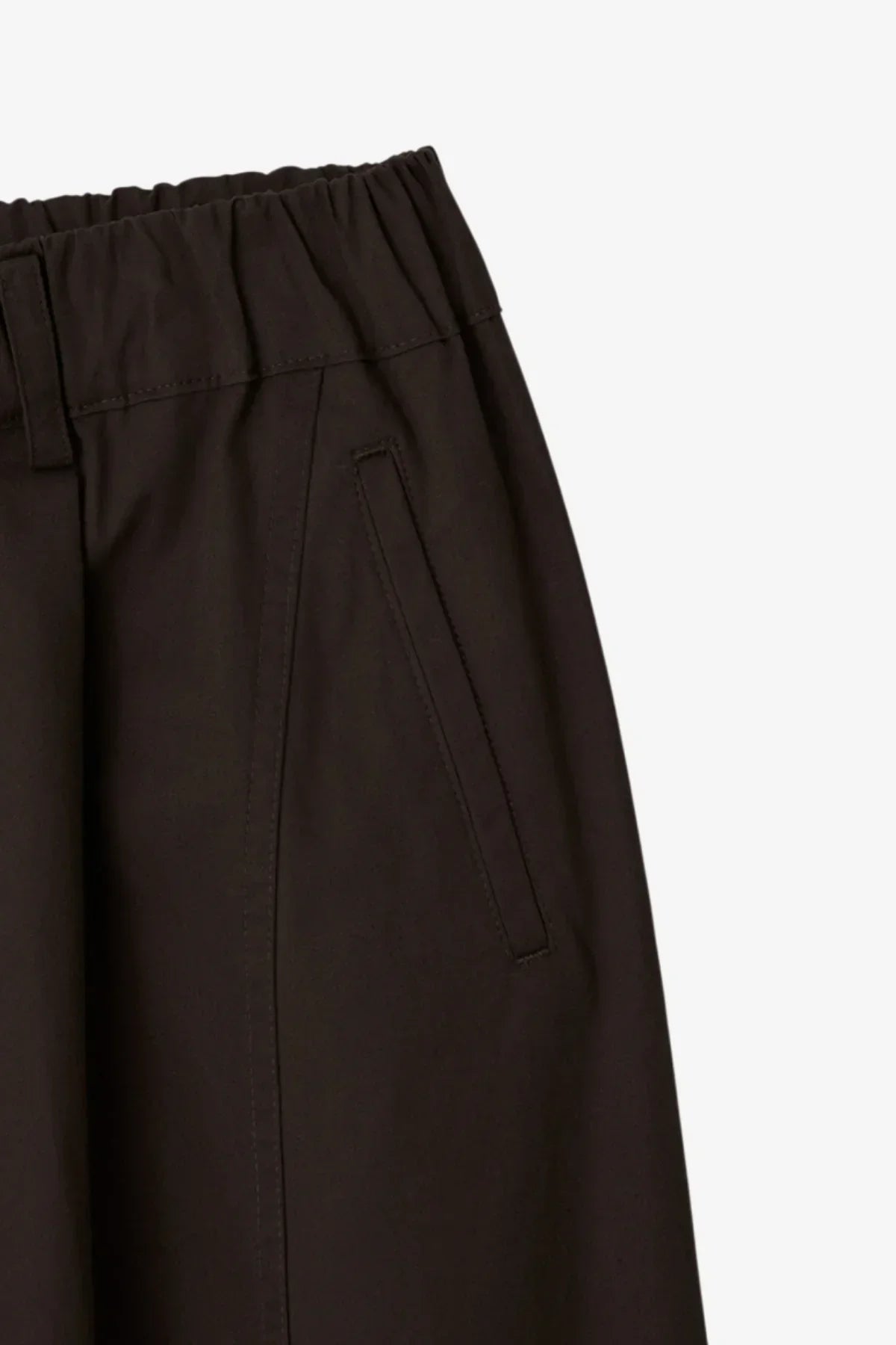 Close-up of brown unisex pants with elastic waistband and angled side pocket