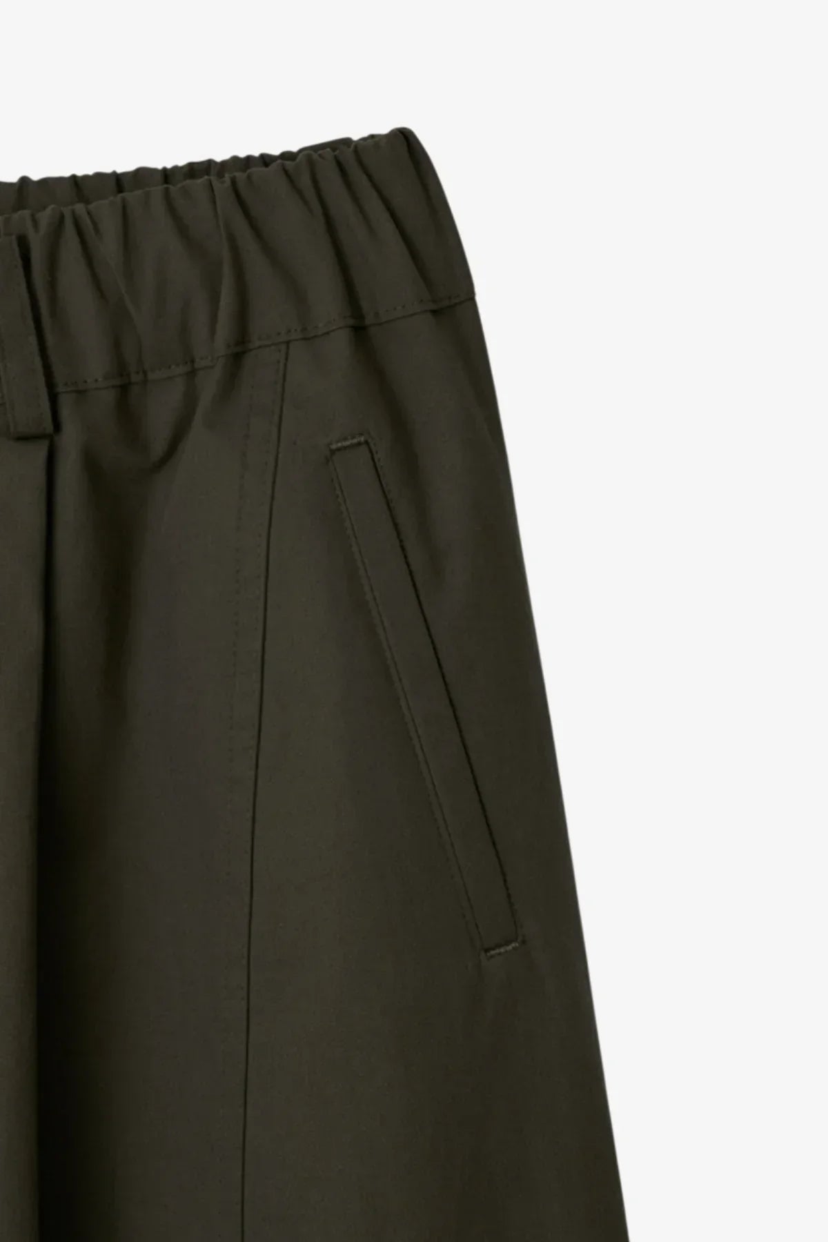 Close-up of khaki unisex pants with elastic waistband and side seam pocket detail