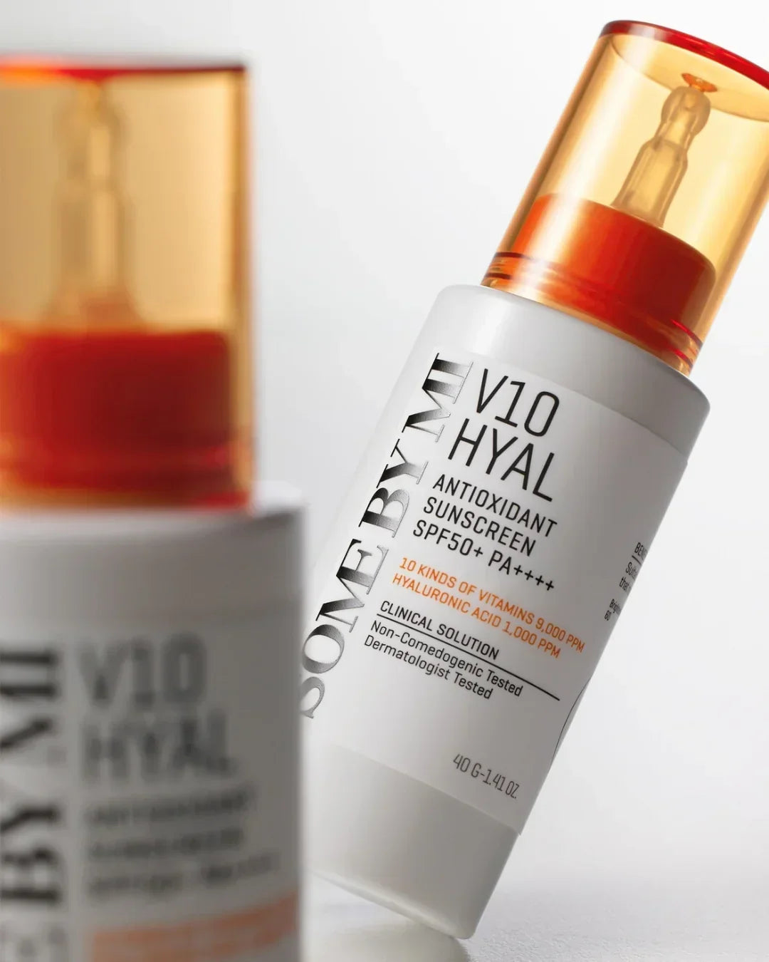 Close-up of V10 HYAL antioxidant sunscreen bottle with SPF50+ PA++++ and orange pump cap on white background