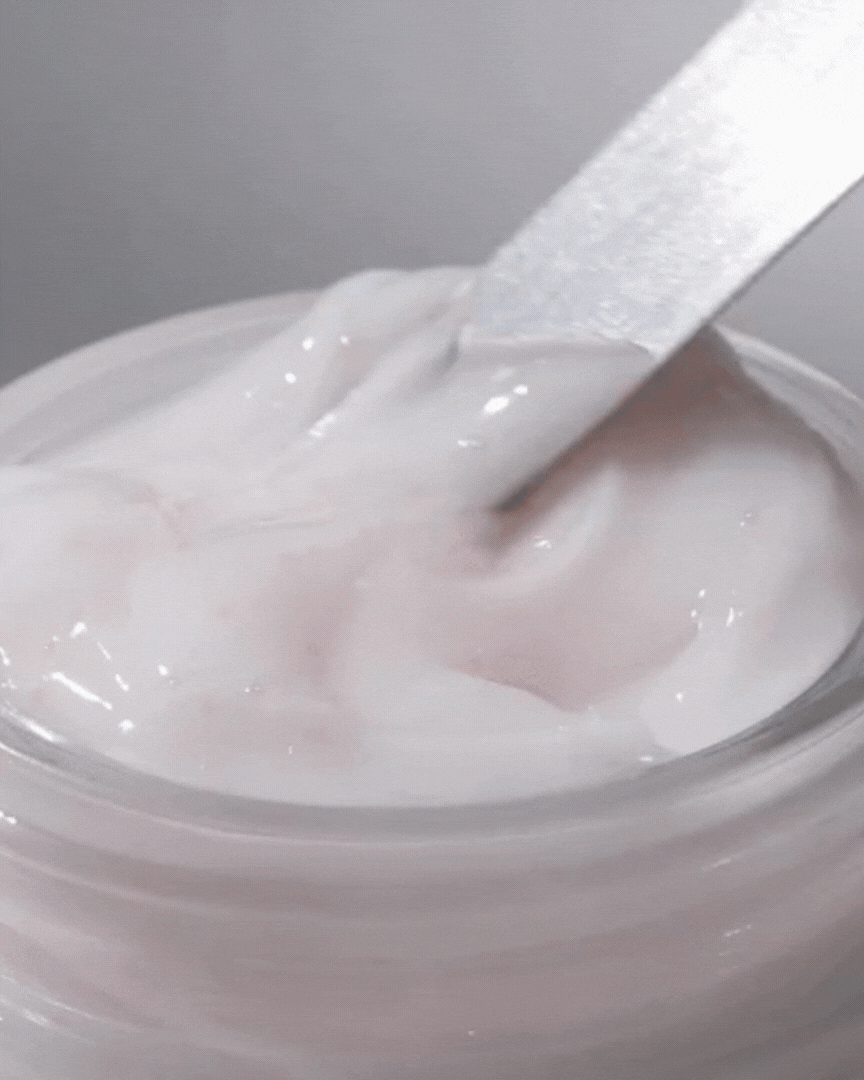 Close-up of creamy vegan active berry lifting cream texture being scooped from jar