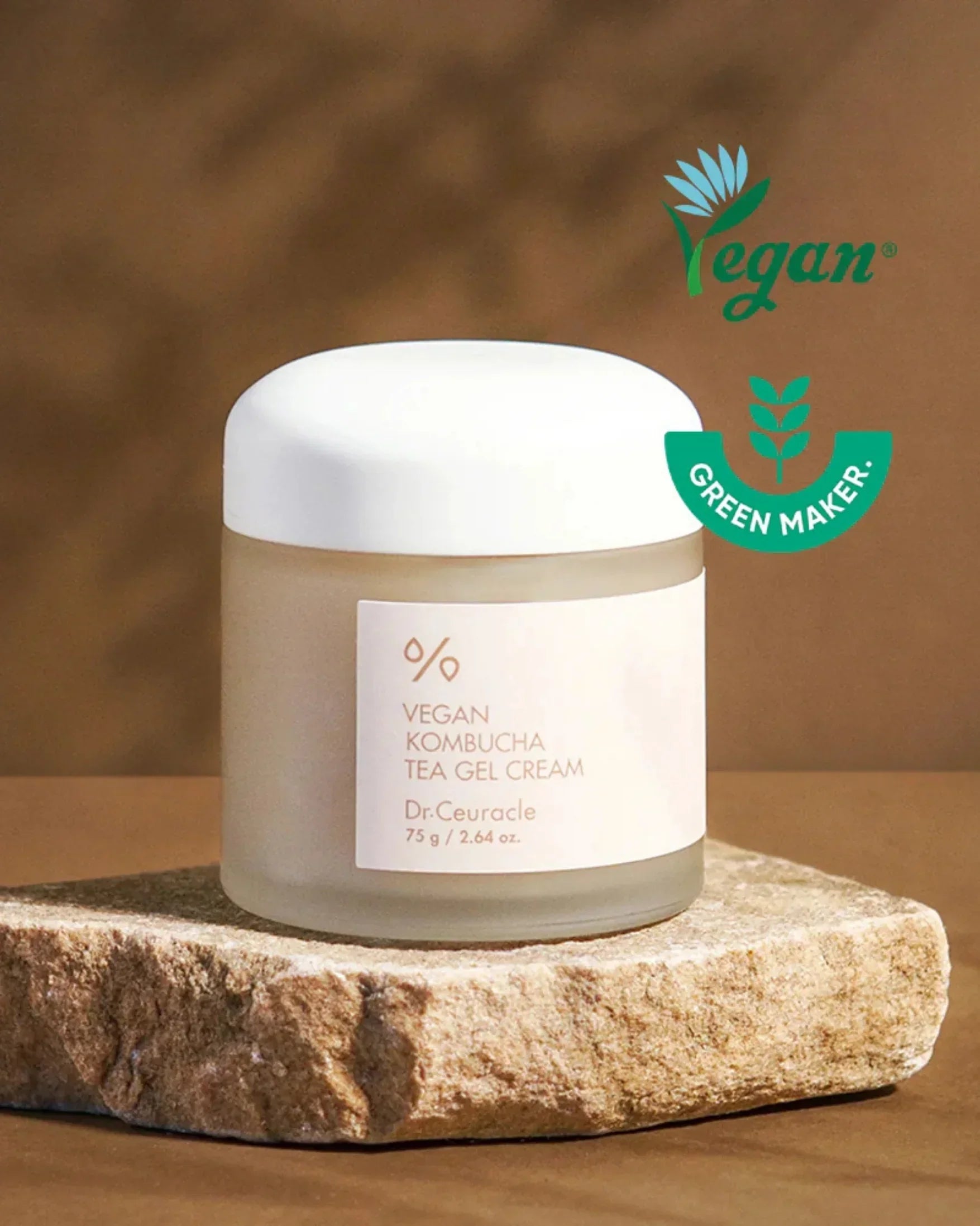 Vegan Kombucha Tea Gel Cream jar on stone slab with green maker label on brown background