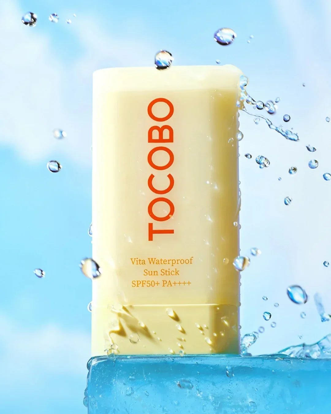 TOCOBO Vita Waterproof Sun Stick SPF50+ PA++++ with water splash on blue ice block
