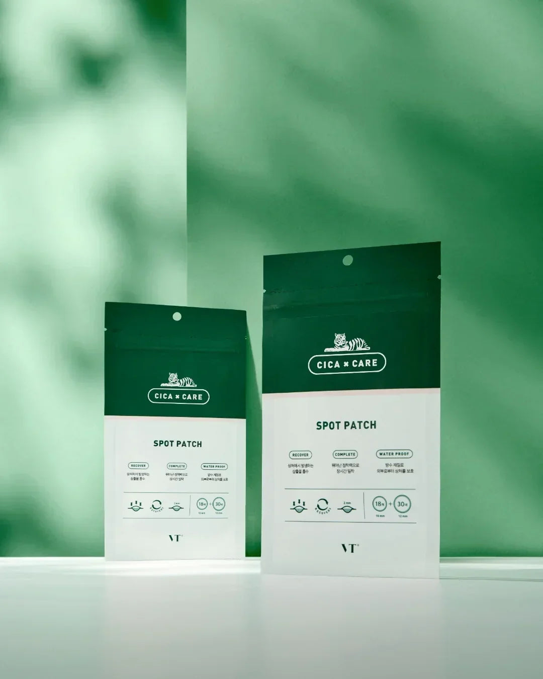 VT Cica Care spot patch skincare product packages with green and white design on white surface
