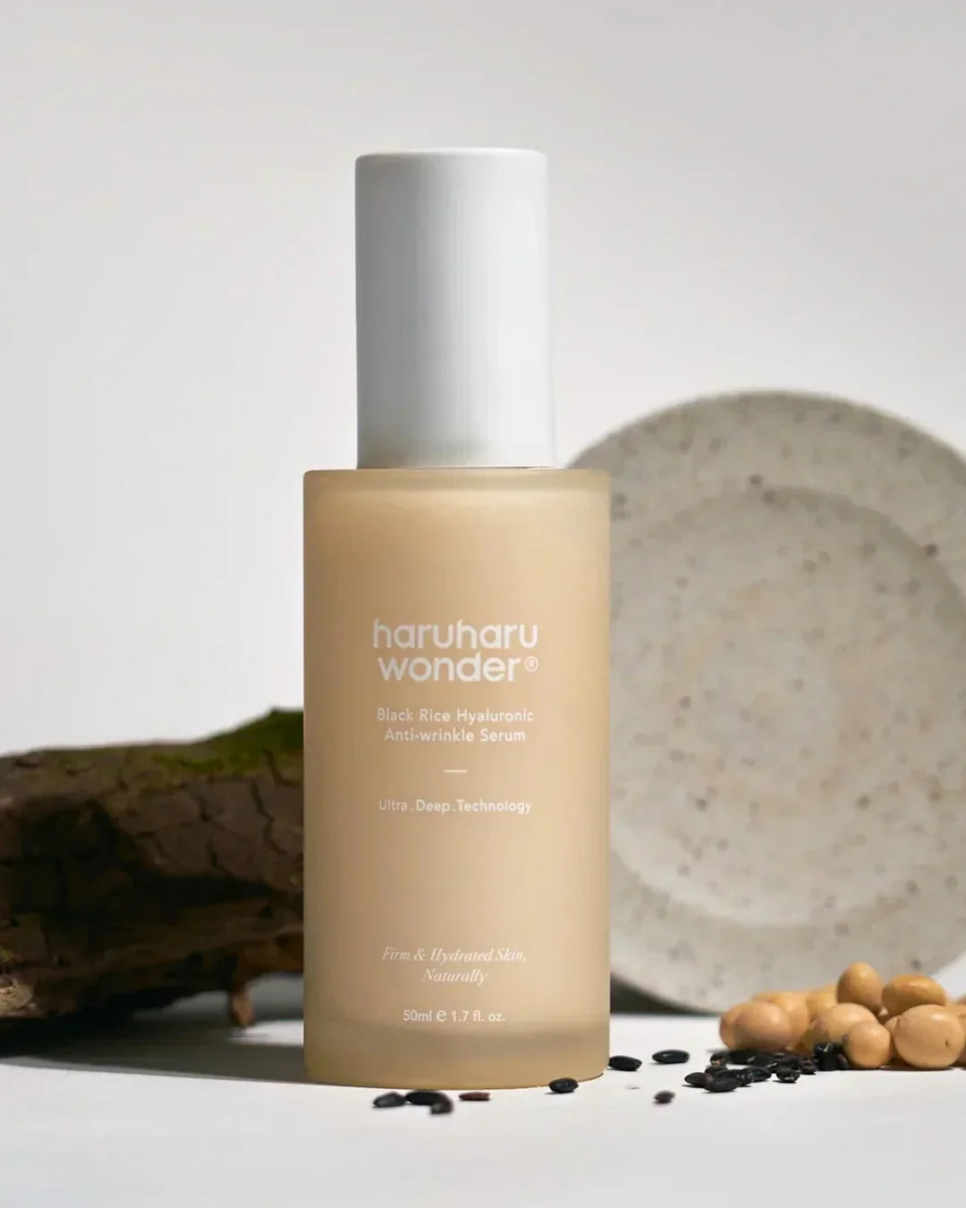 Haruharu Wonder Black Rice Hyaluronic Anti-wrinkle Serum bottle with natural ingredients backdrop