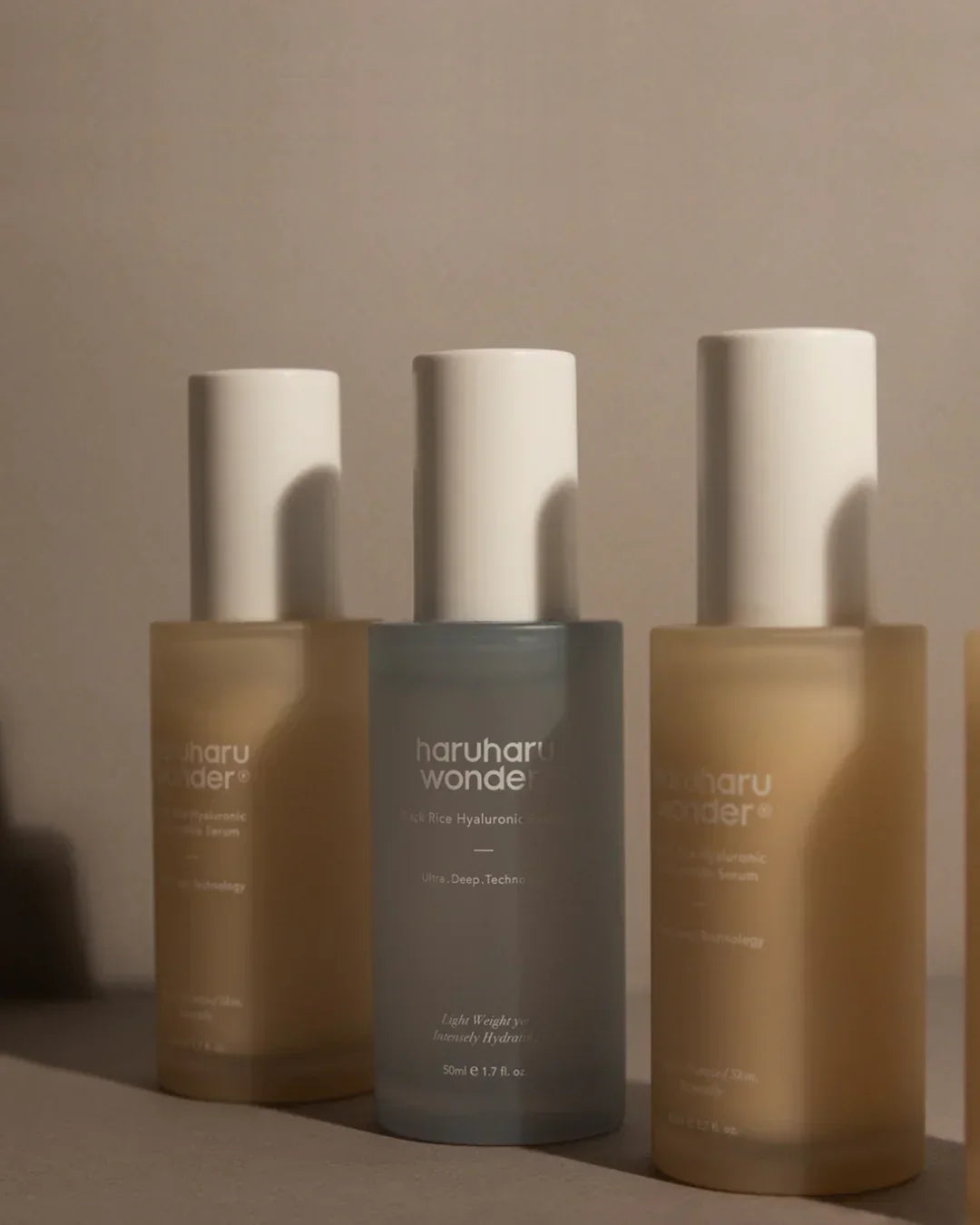 Haruharu Wonder Black Rice Hyaluronic Anti-Wrinkle Serum 50ml bottles with white caps on beige background