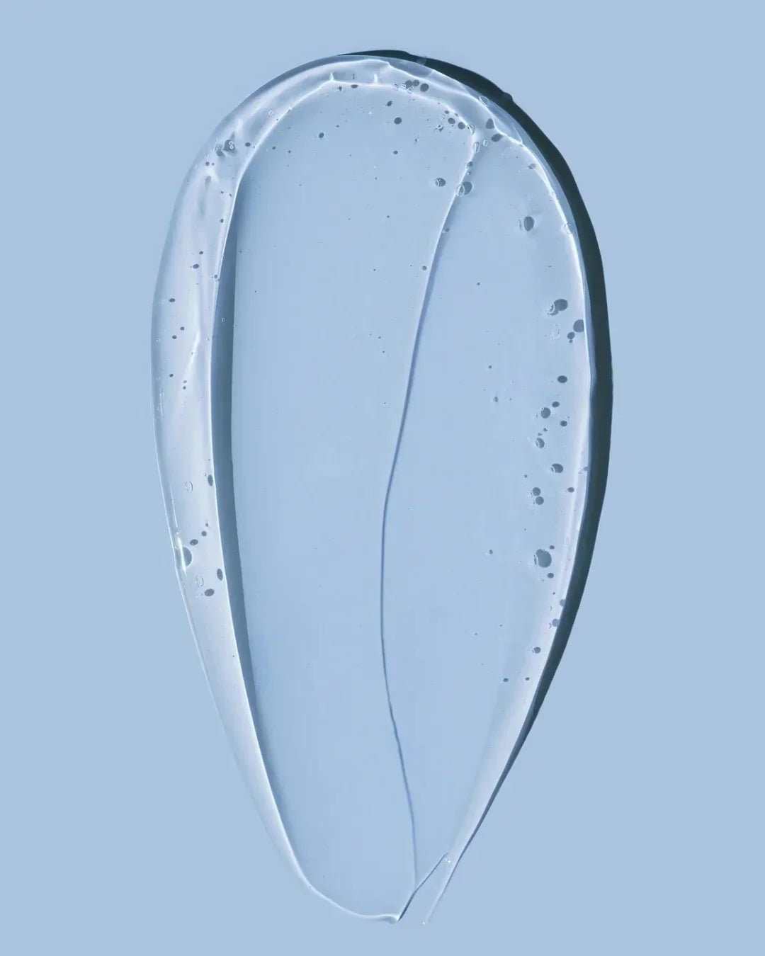 Clear gel texture on light blue background showing hydrating skincare essence consistency