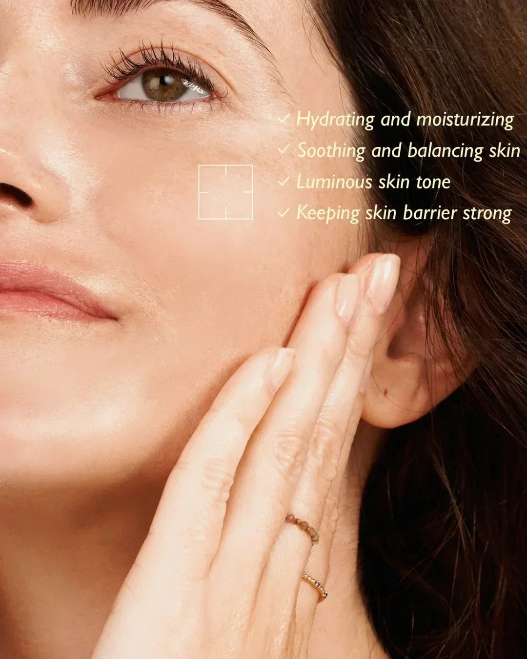 Close-up of woman gently touching her cheek with text listing skin benefits like hydrating and moisturizing