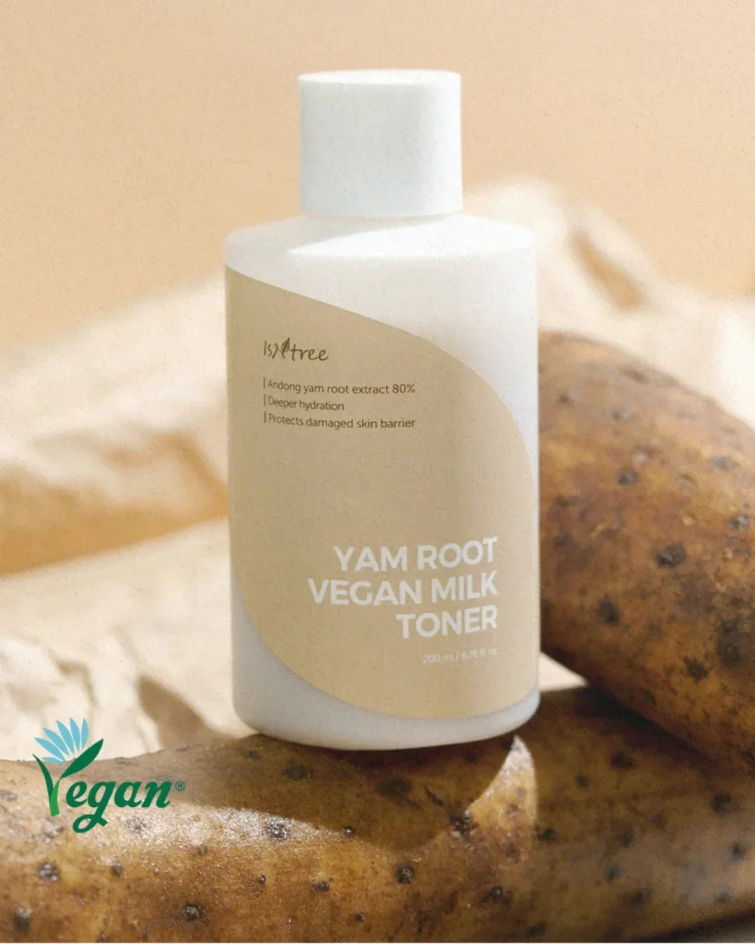 Isntree Yam Root Vegan Milk Toner bottle with fresh yam roots on beige background