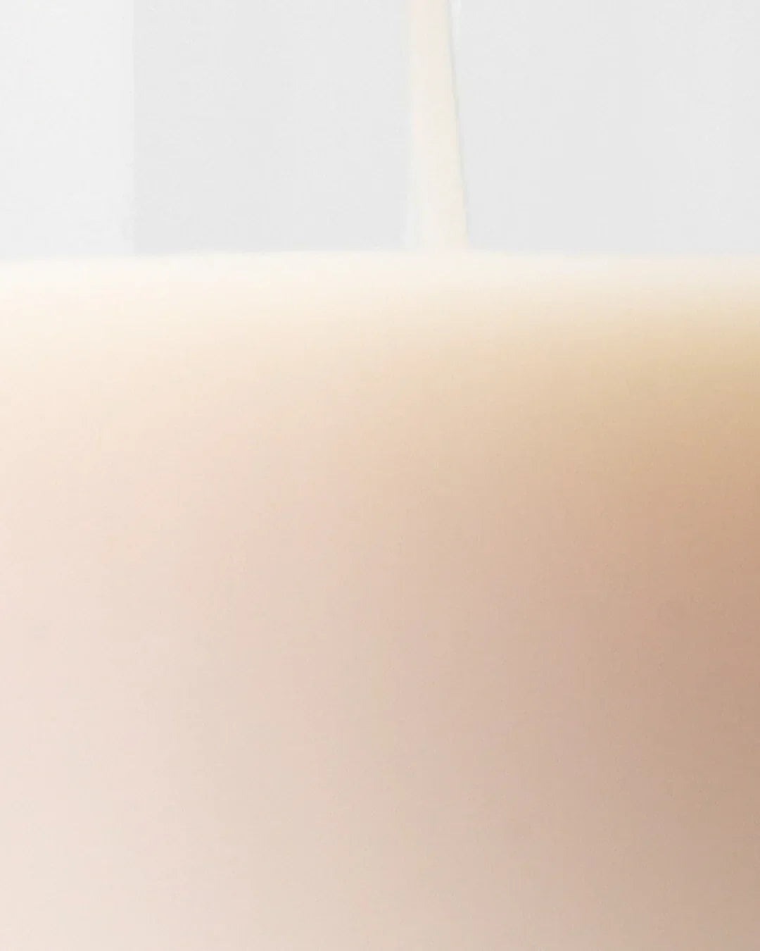 Close-up of creamy beige yam root vegan milk toner pouring, smooth liquid texture