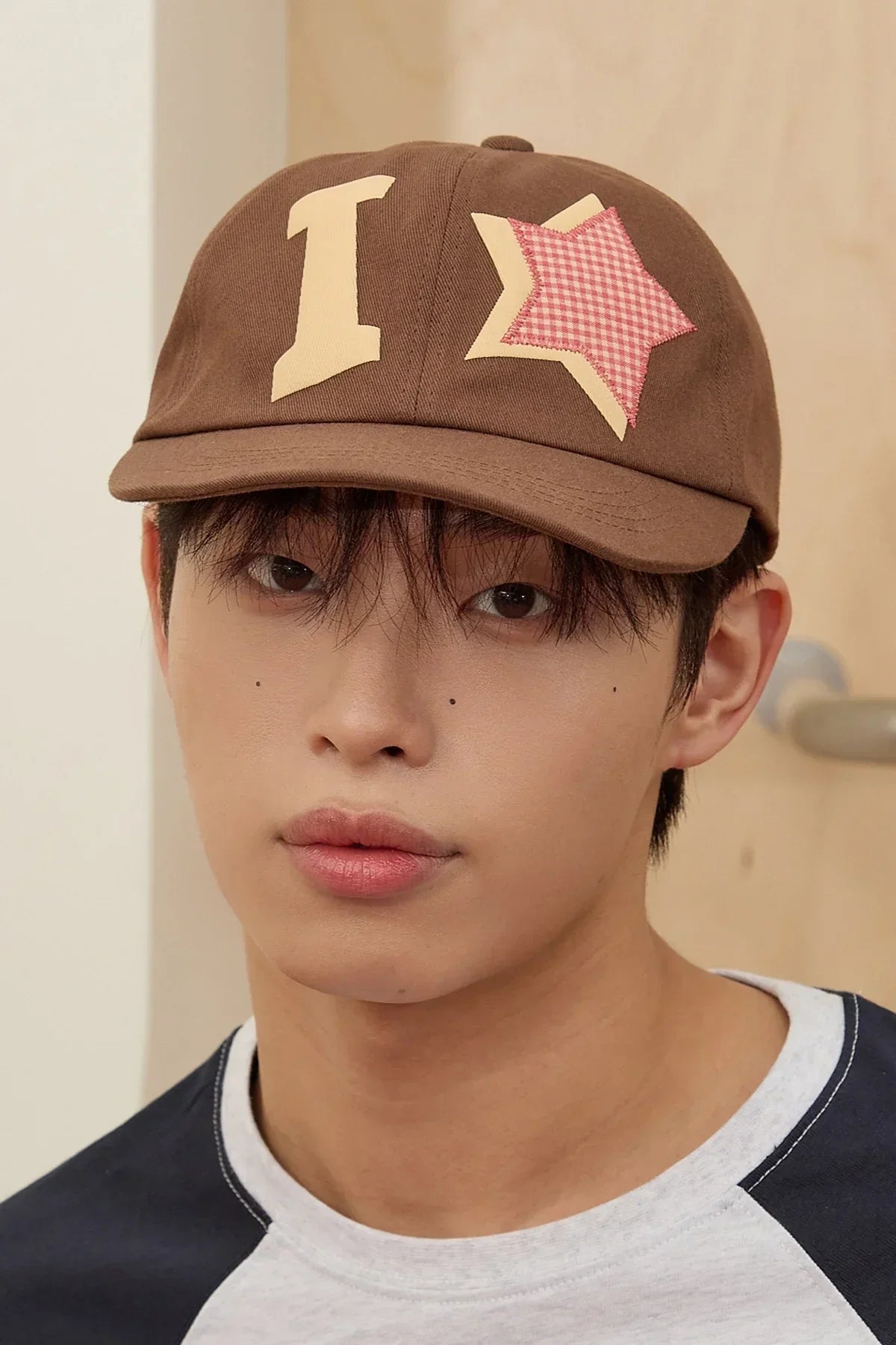 Model wearing brown I star applique ball cap from Korean fashion on Malkn lifestyle store