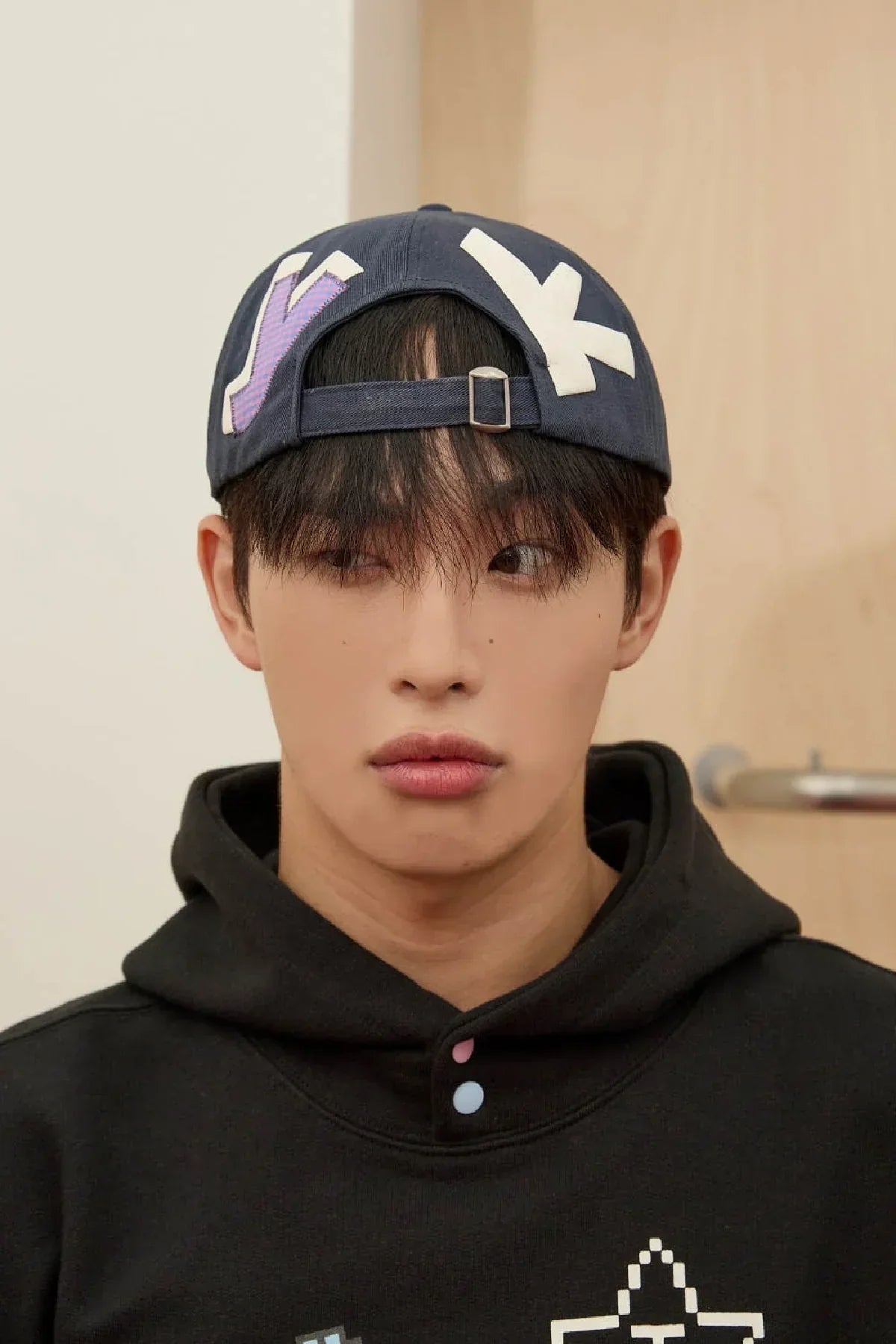 Model wearing navy YK check applique ball cap, Korean fashion hoodie, indoors, Malkn lifestyle
