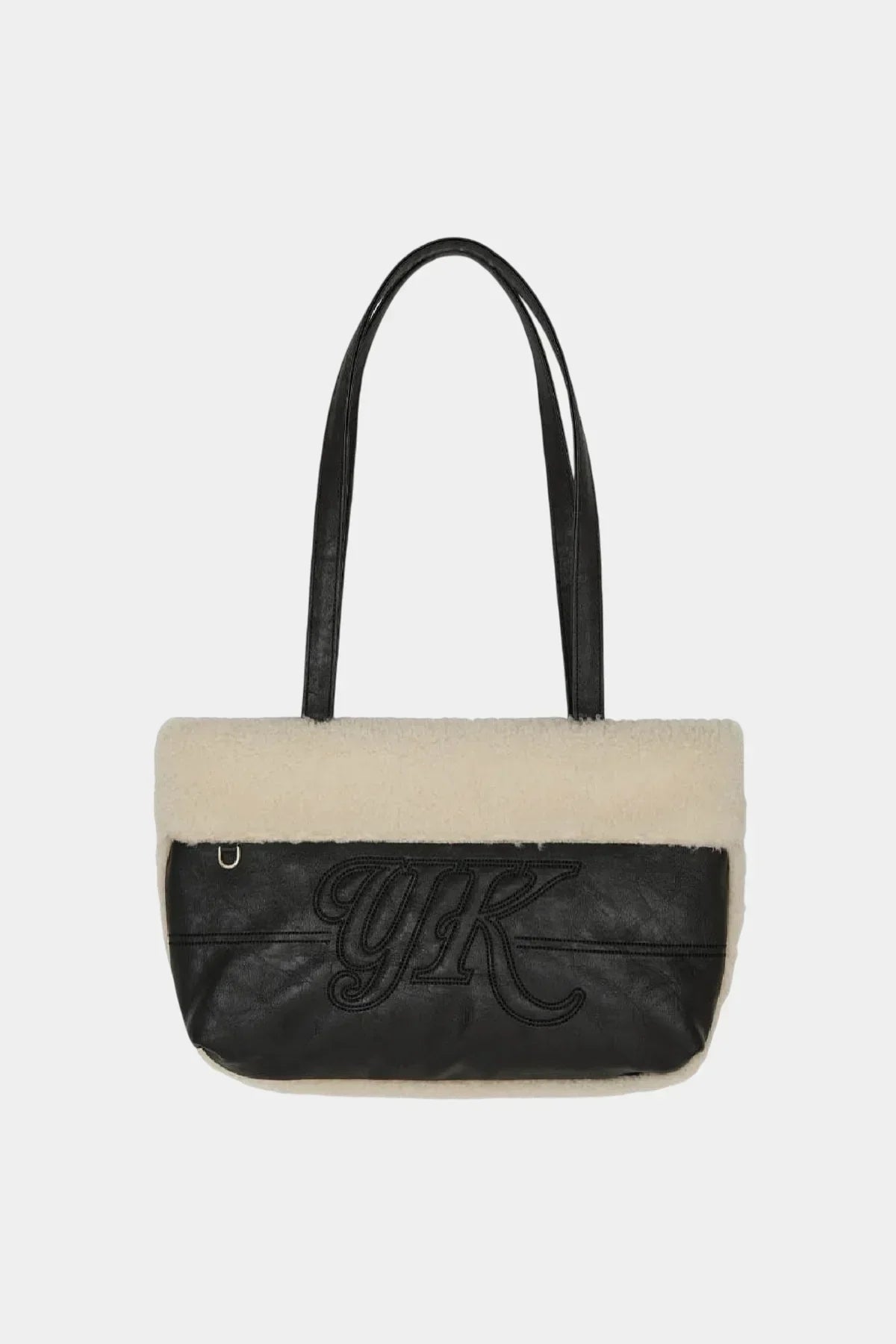 Black leather shoulder bag with cream shearling trim and embroidered YK logo