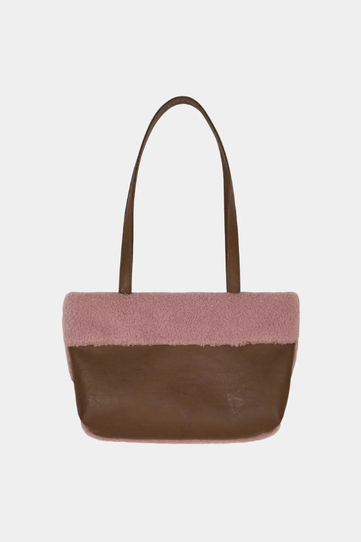 Brown leather shoulder bag with pink shearling upper trim and long handles on white background