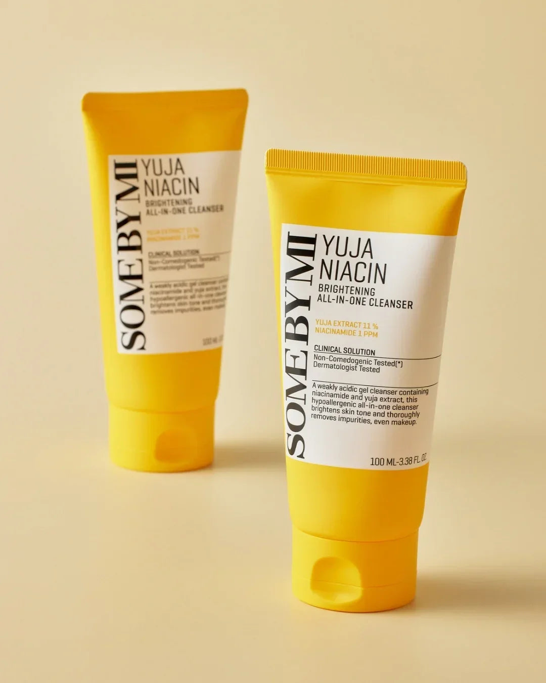 SOMEBYMI Yuja Niacin brightening all-in-one cleanser 100ml yellow tube on beige background