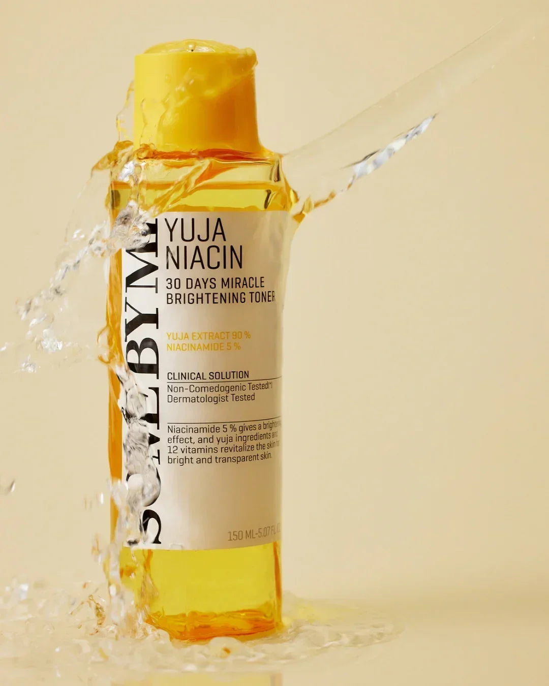 SOME BY MI Yuja Niacin 30 Days Miracle Brightening Toner bottle with splash of water on beige background
