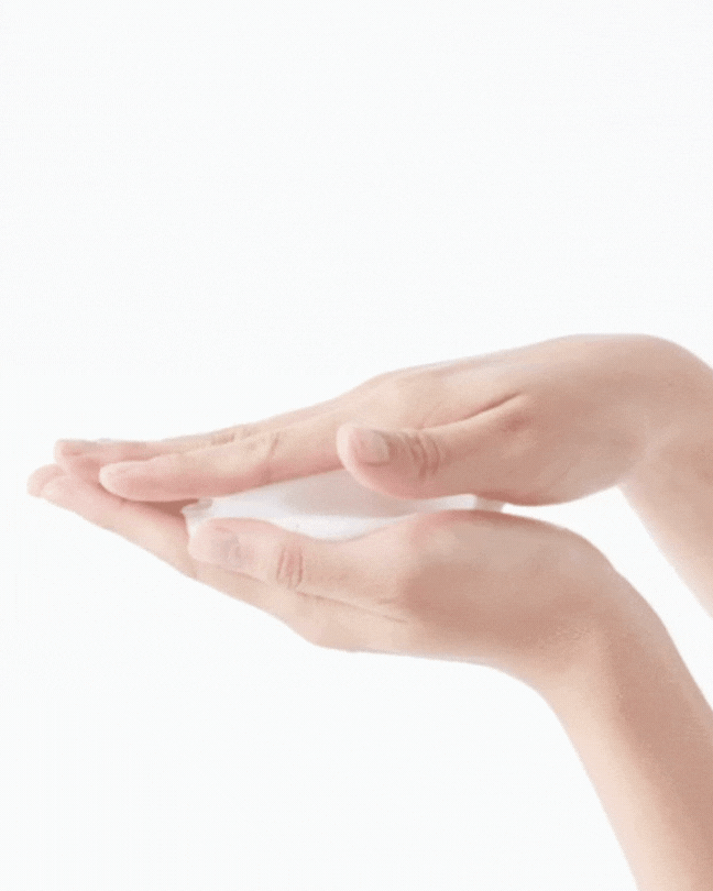 Hands holding and rubbing white foam cleanser on a white background, skincare routine
