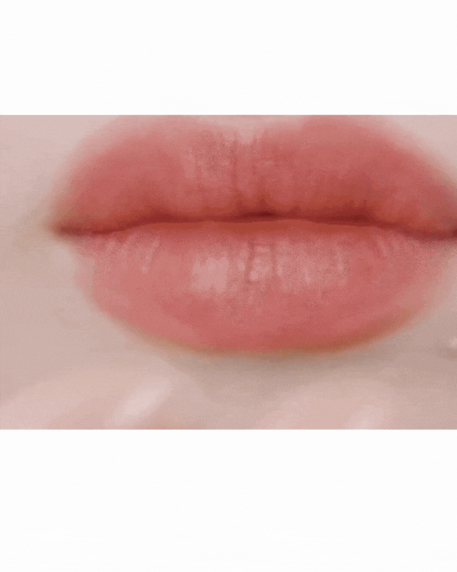 Close-up of lips applying smooth, natural matte lipstick in soft pink shade, showcasing even color and texture