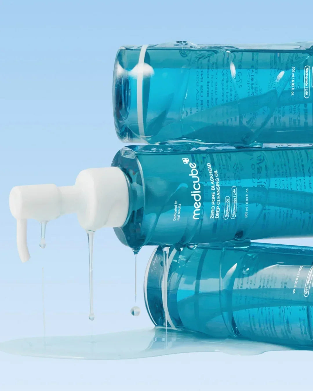 Medicube Zero Pore Blackhead Deep Cleansing Oil bottles with blue liquid and white pump, Korean beauty skincare, Malkn UK.