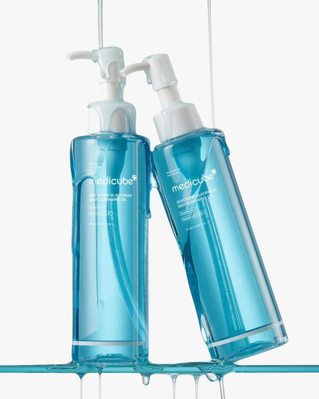 Twin bottles of Medicube Zero Pore Blackhead Deep Cleansing Oil with blue liquid, Korean skincare
