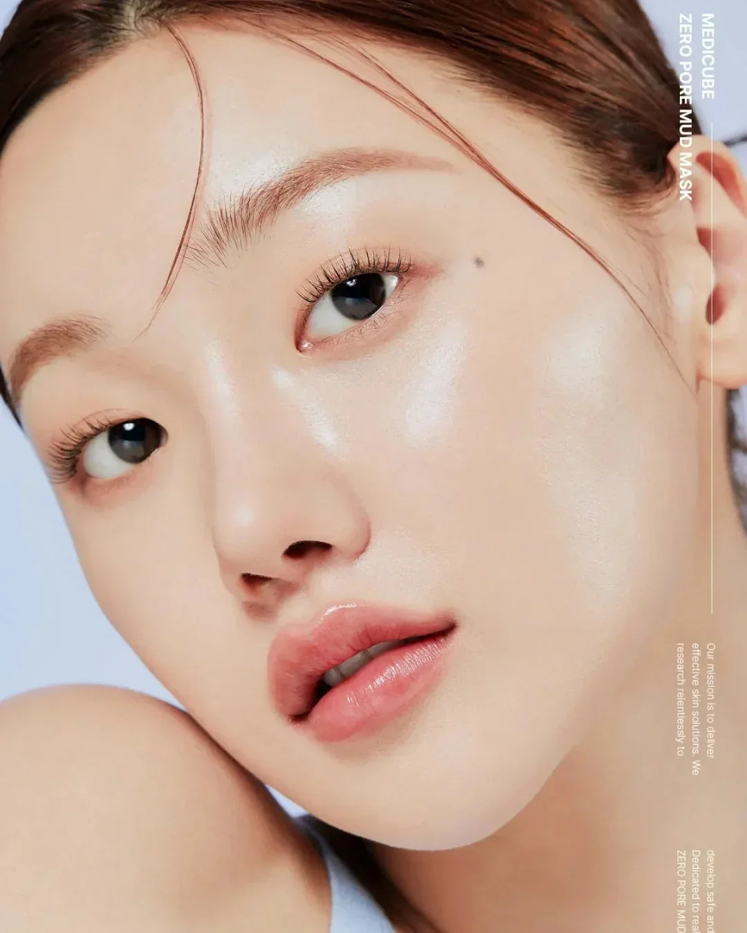 Close-up of a young woman with clear, glowing skin showcasing smooth complexion and natural beauty