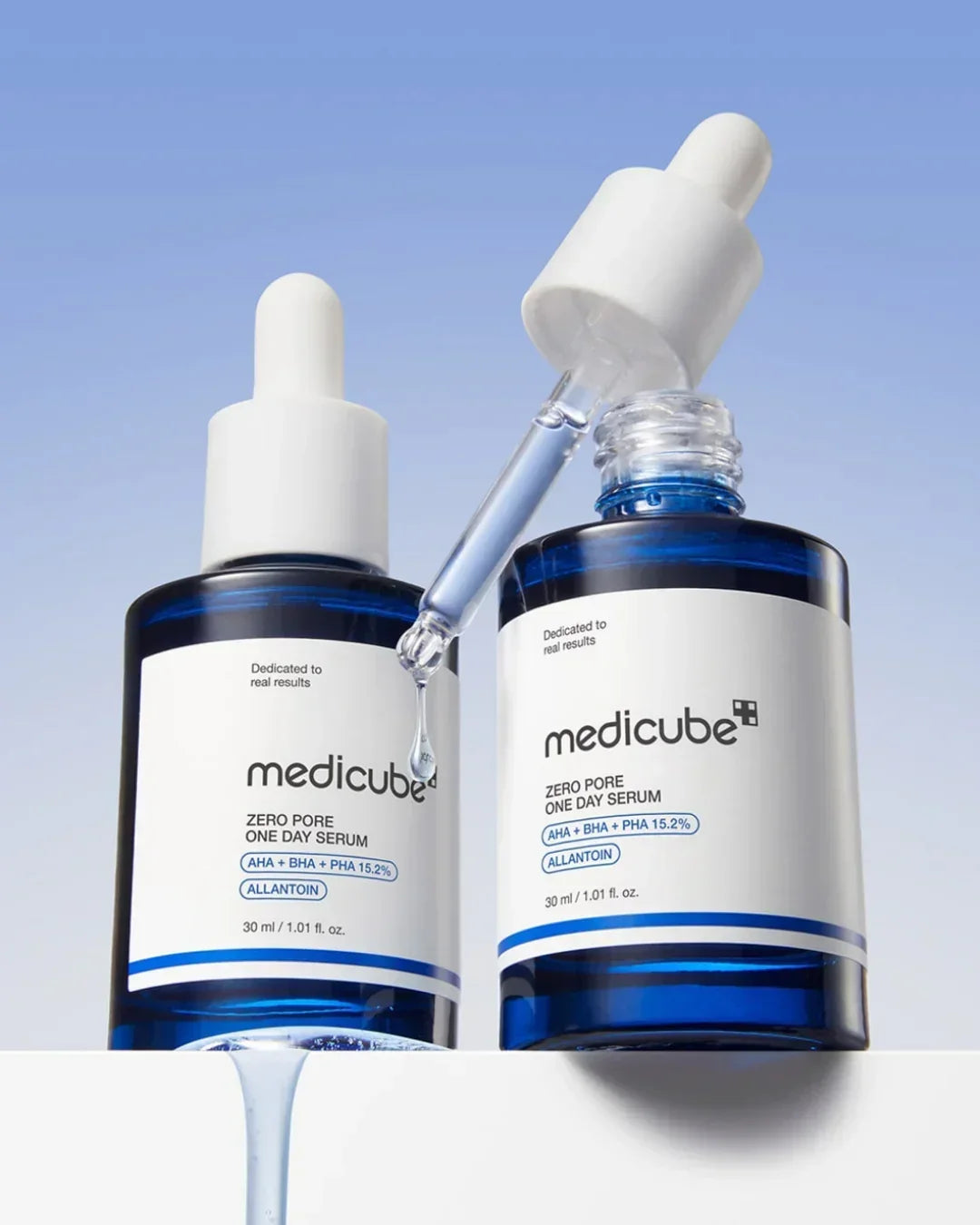 Medicube Zero Pore One Day Serum bottles with dropper and blue liquid on white surface